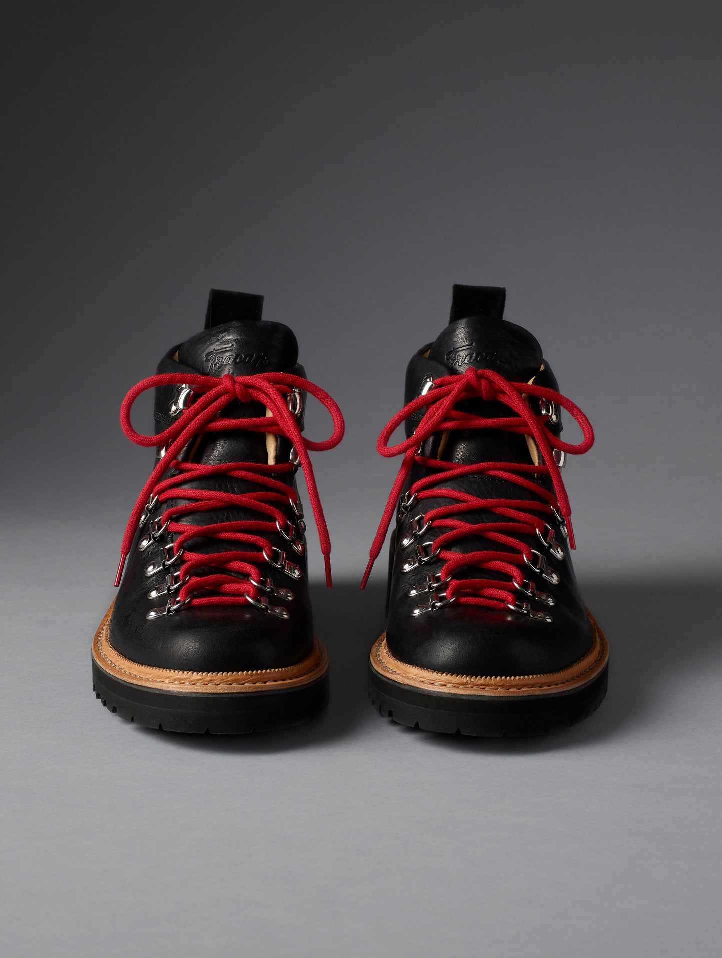 Front view of women’s Dolomite Boot in Onyx Black from AETHER Apparel with red laces.