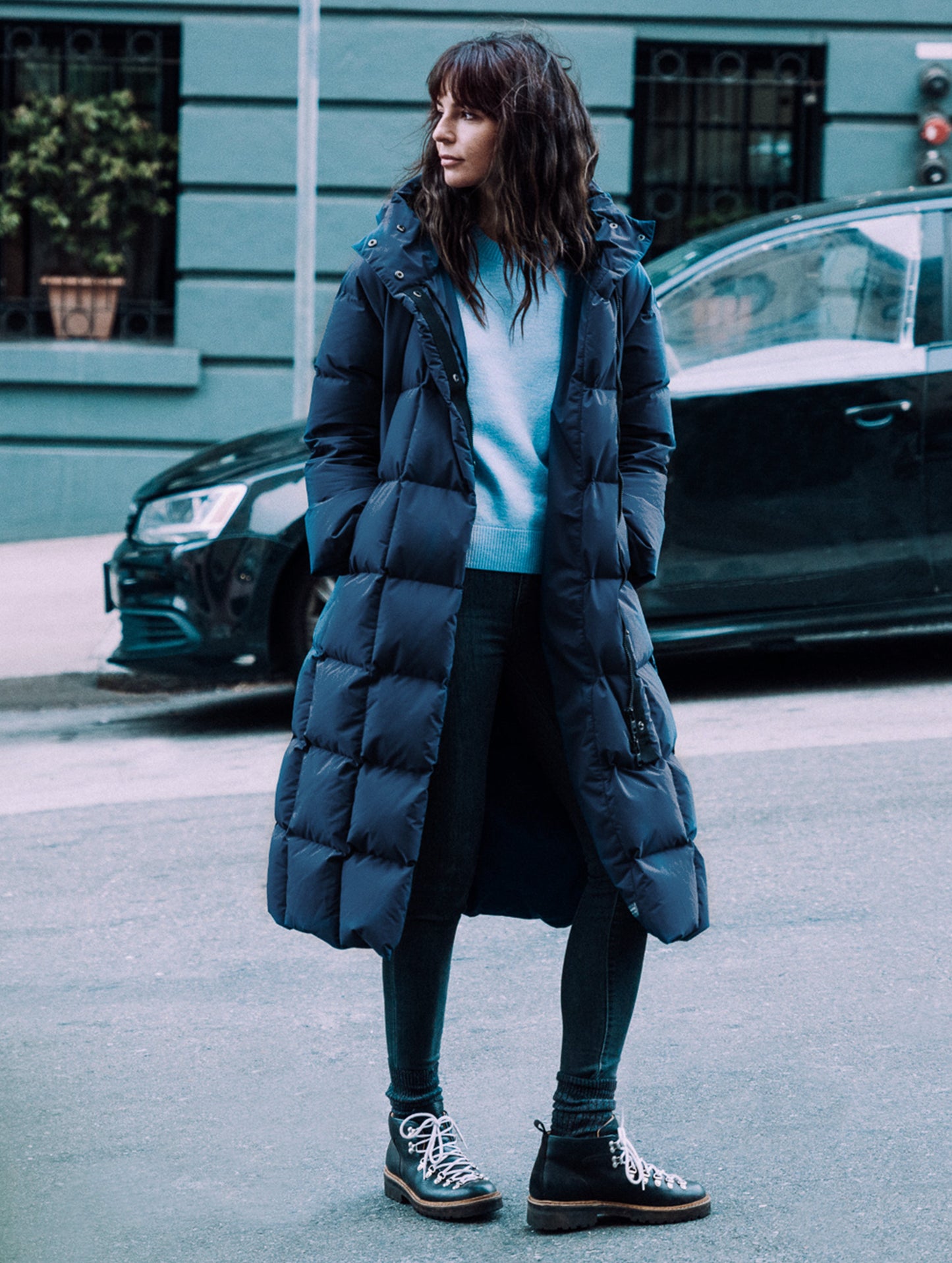 Outdoor lifestyle image of woman standing in city street wearing Dolomite Boot in Onyx Black from AETHER Apparel.