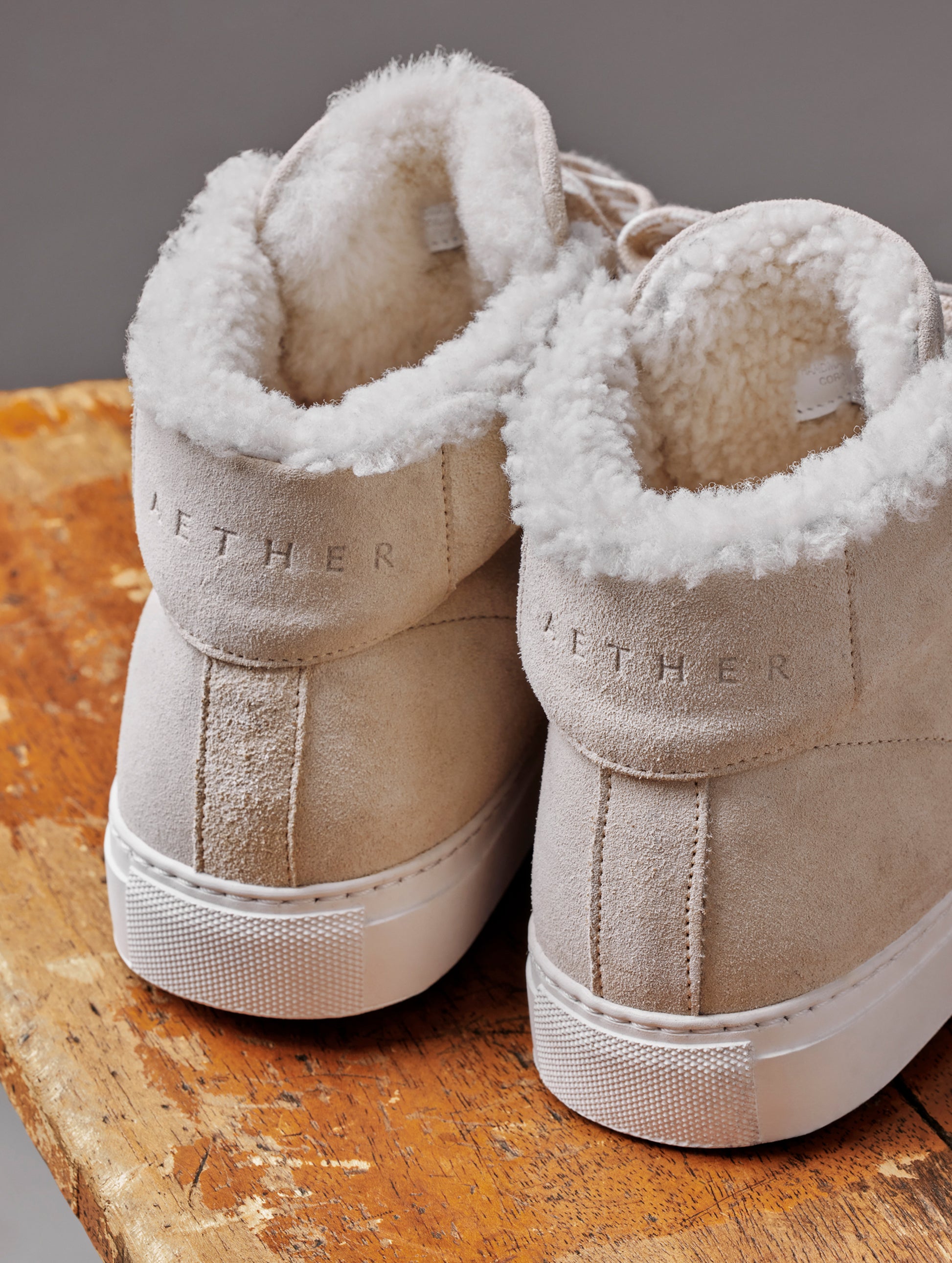 Closeup detailed view of heel and shearling lining of women's Durham Sneaker with Shearling in Bone white from AETHER Apparel.