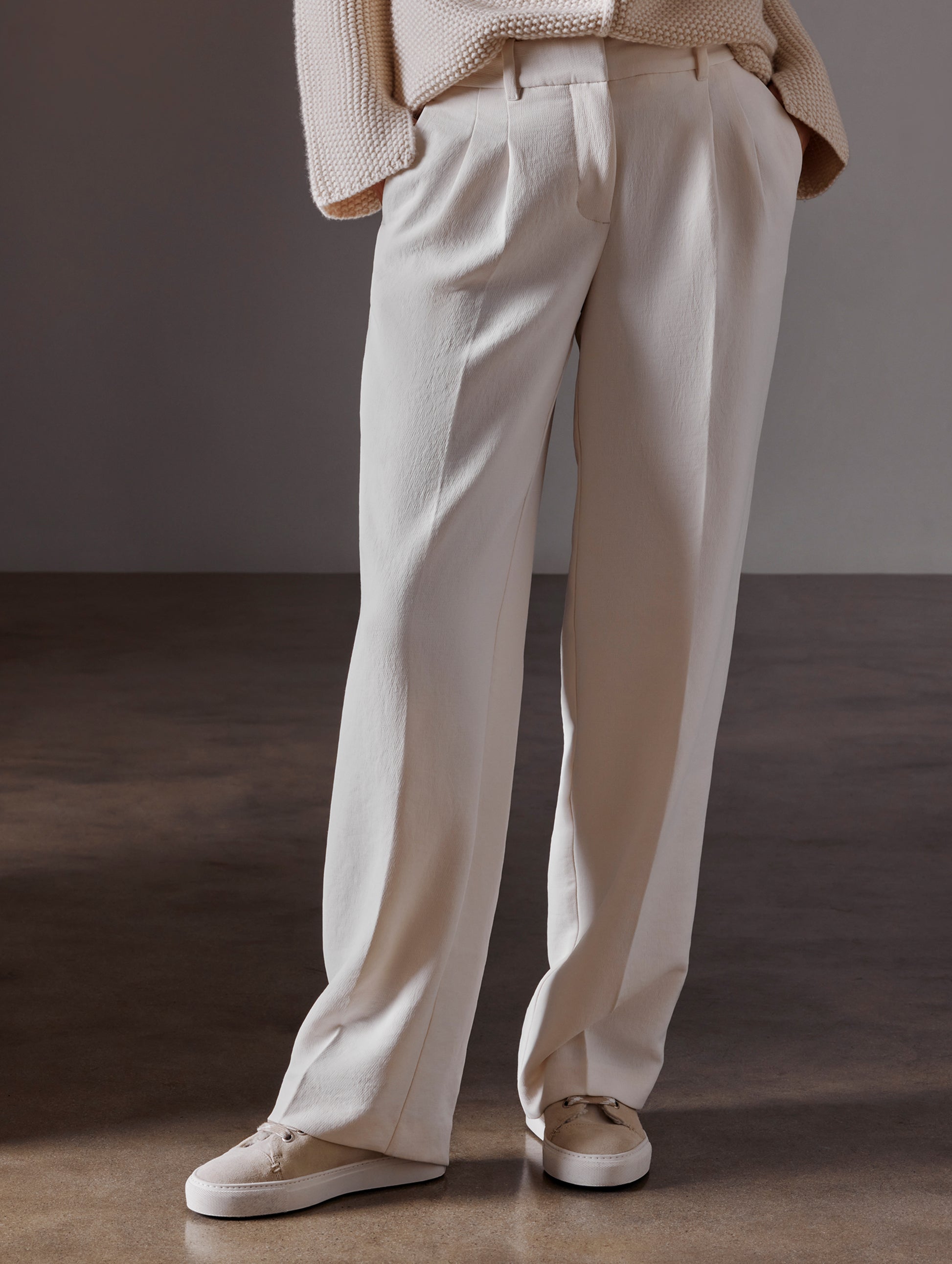 Front lower body view of woman wearing Durham Sneaker with Shearling in Bone white from AETHER Apparel.
