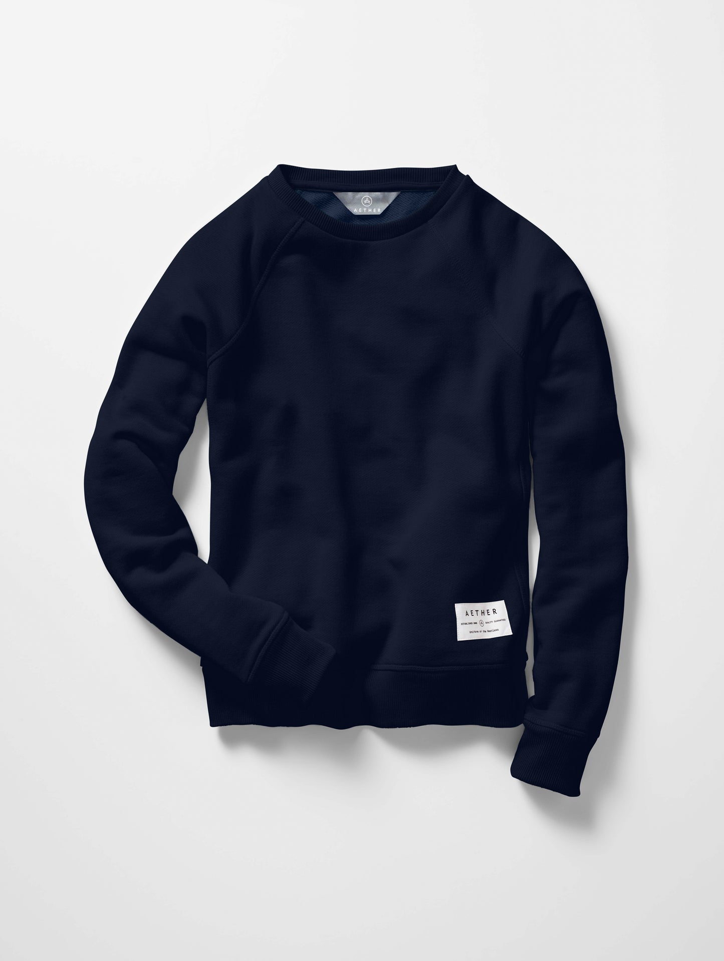 Flat lay of women's Foundation Raglan Sweatshirt in Nordic Navy blue from AETHER Apparel.