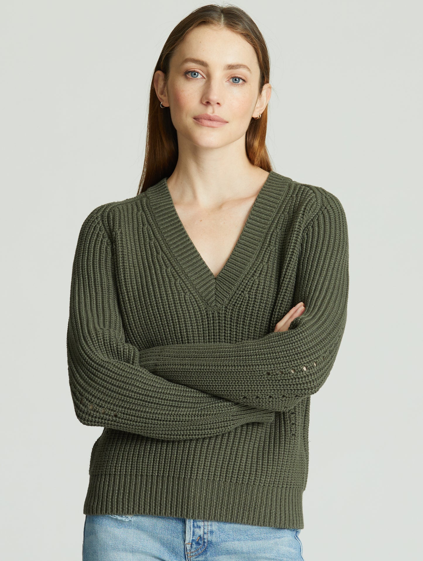 Front view of woman wearing green Keaton Sweater from AETHER Apparel.