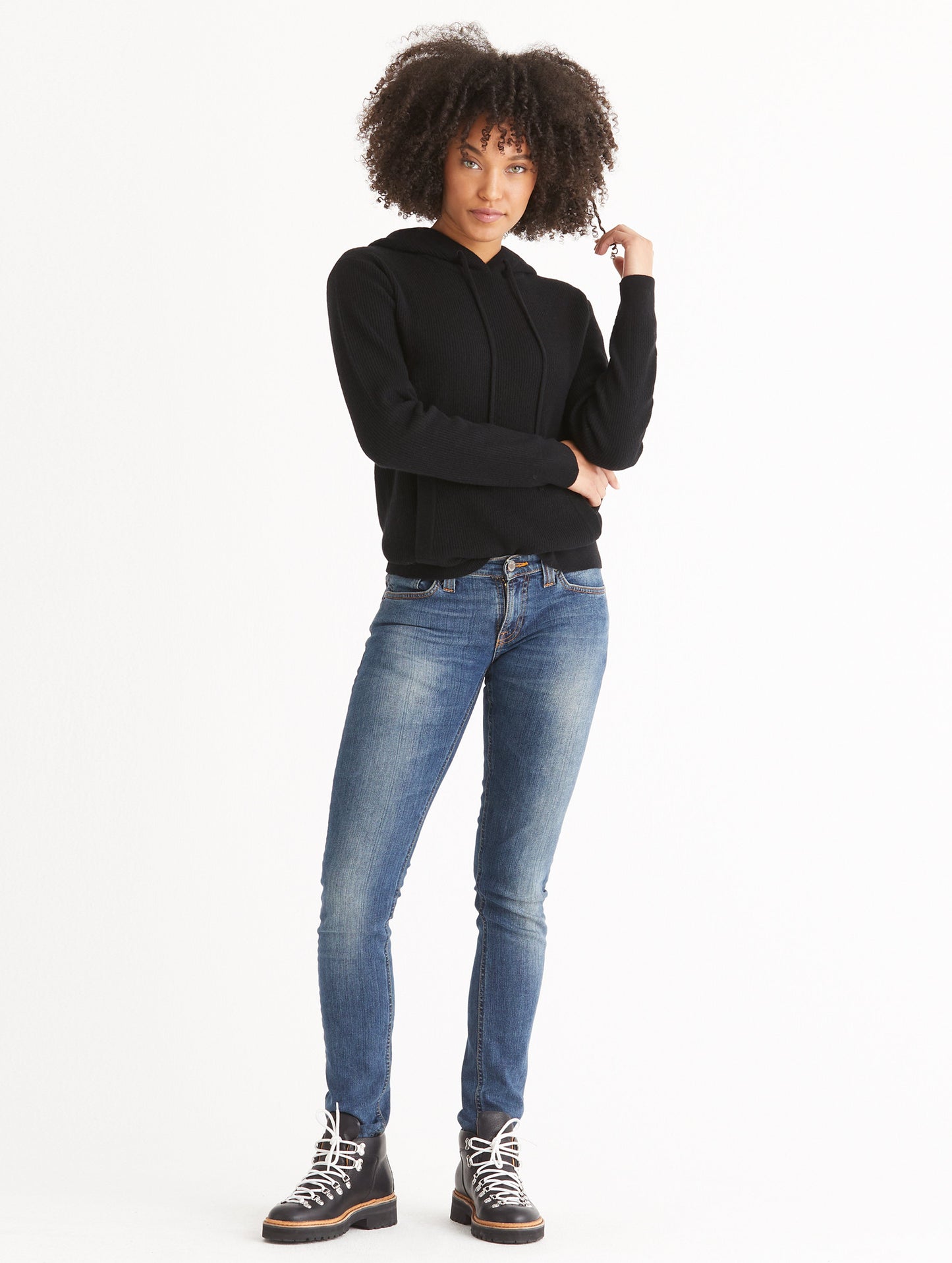 Front full-body view of woman wearing Lawrence Cashmere Hooded Sweater in Onyx Black from AETHER Apparel.