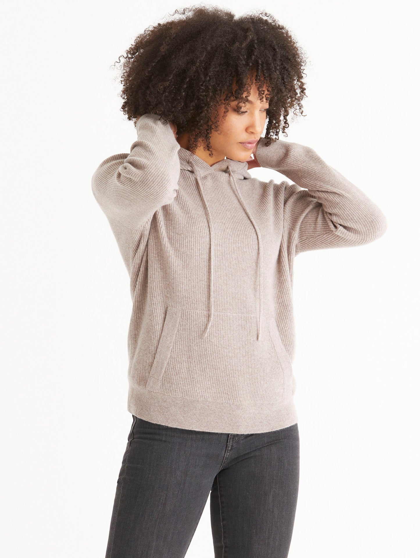 Front angled view of woman wearing Lawrence Cashmere Hooded Sweater in Toast Brown from AETHER Apparel.