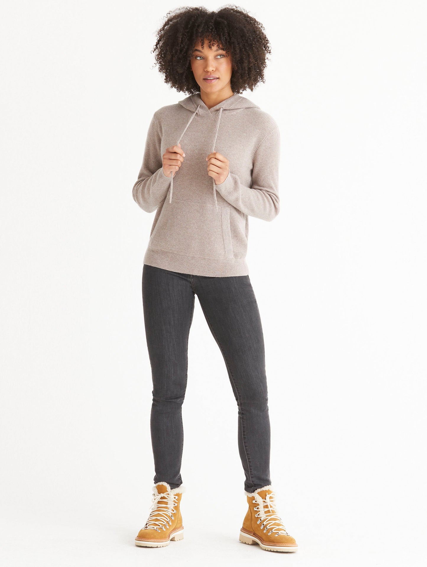 Front full-body view of woman wearing Lawrence Cashmere Hooded Sweater in Toast Brown from AETHER Apparel.