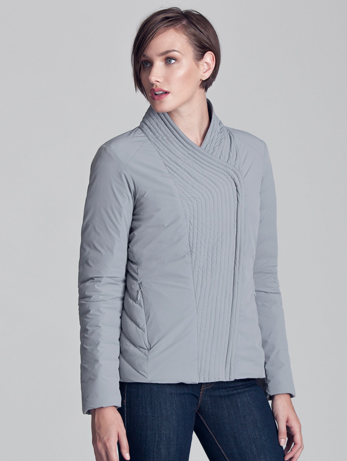 Woman wearing closed grey Passport Jacket from AETHER Apparel.