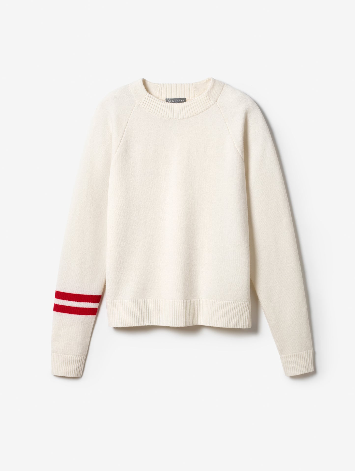 Flat lay of women's Racer Sweater in Winter White from AETHER Apparel.
