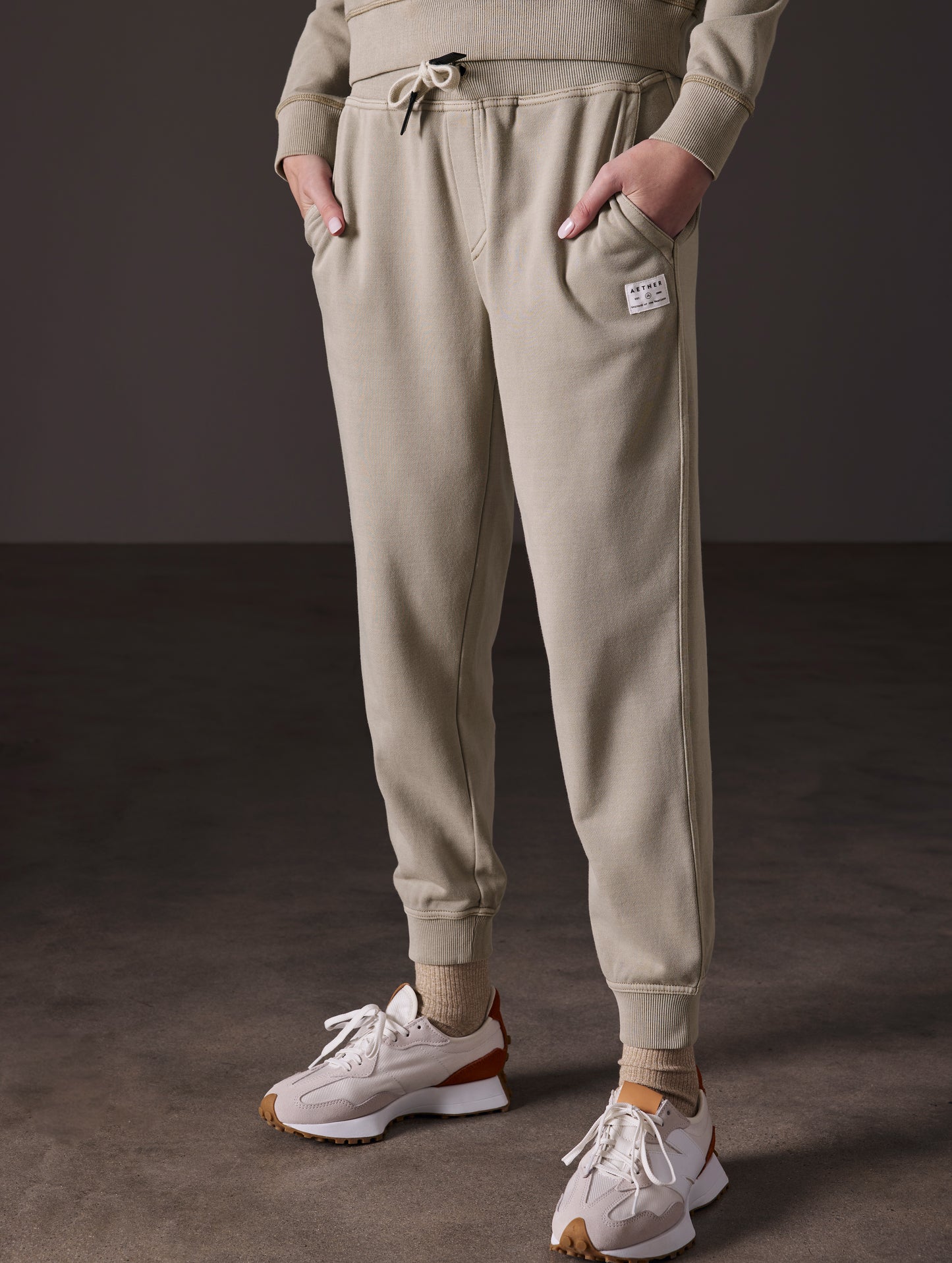 Front angled lower body view of woman wearing Solstice Lightweight Jogger in Laurel Grey from AETHER Apparel.