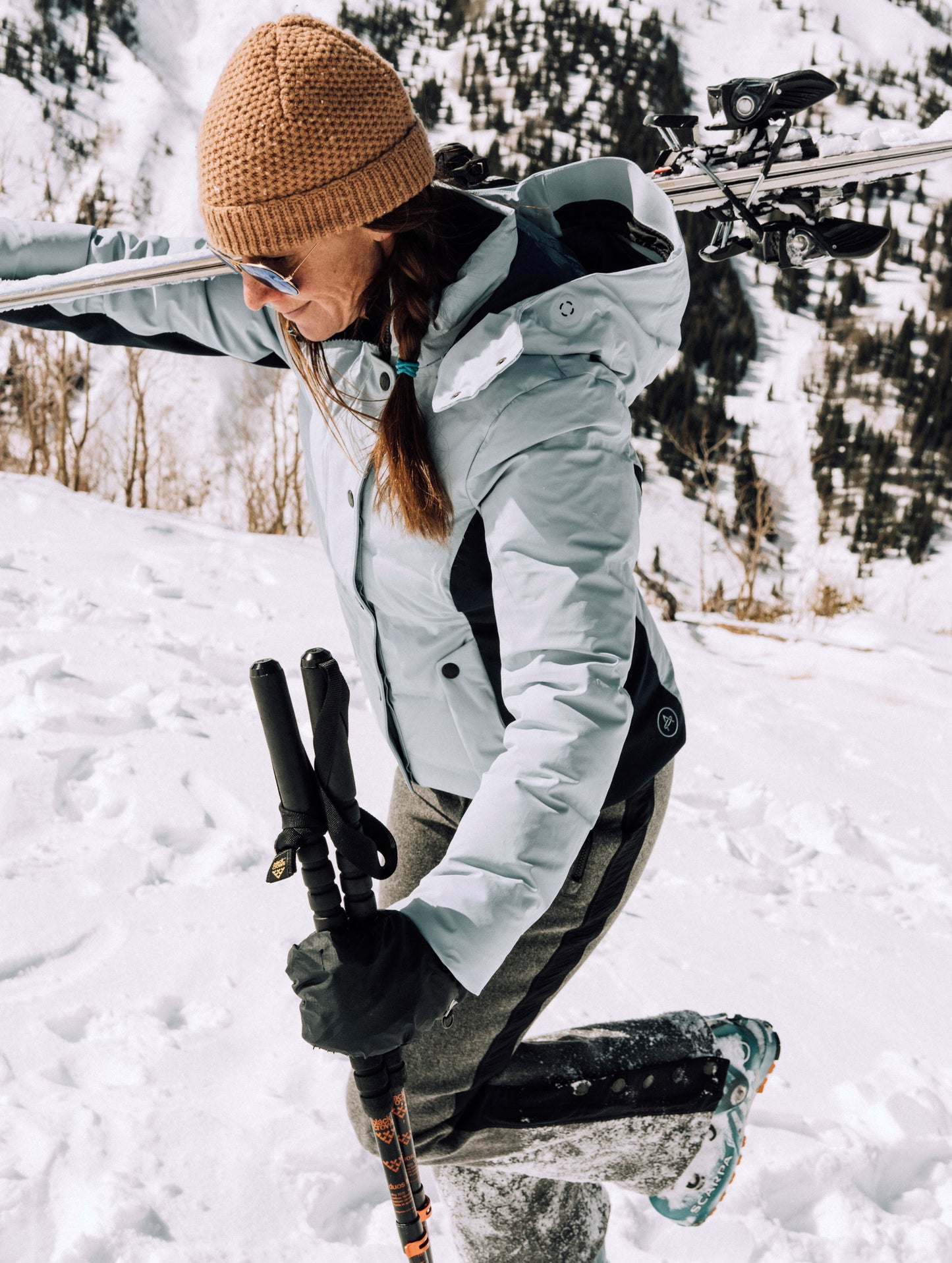 woman wearing light blue ski jacket from Aether Apparel