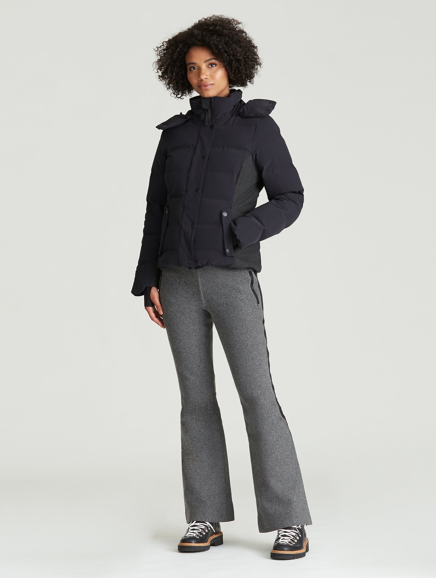 Front angled full-body view of woman wearing Torino Jacket in Onyx Black from AETHER Apparel.