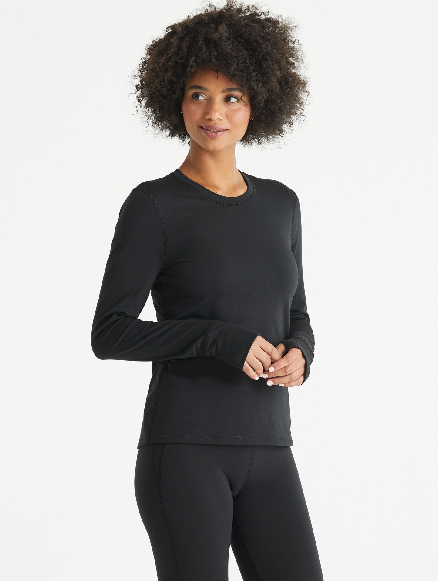 Woman wearing black Vapor Base Layer long-Sleeve shirt from AETHER Apparel.