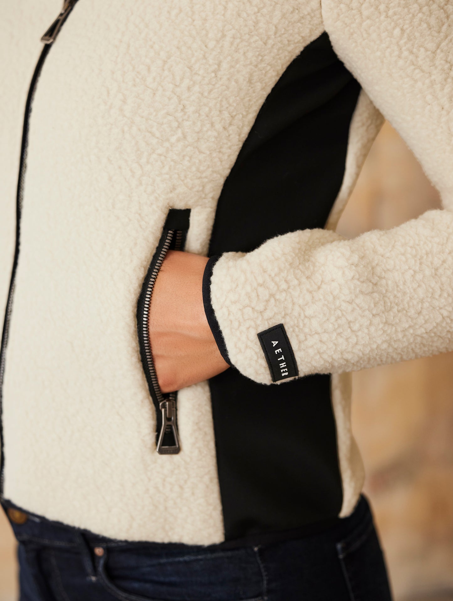 woman wearing beige full-zip sweater