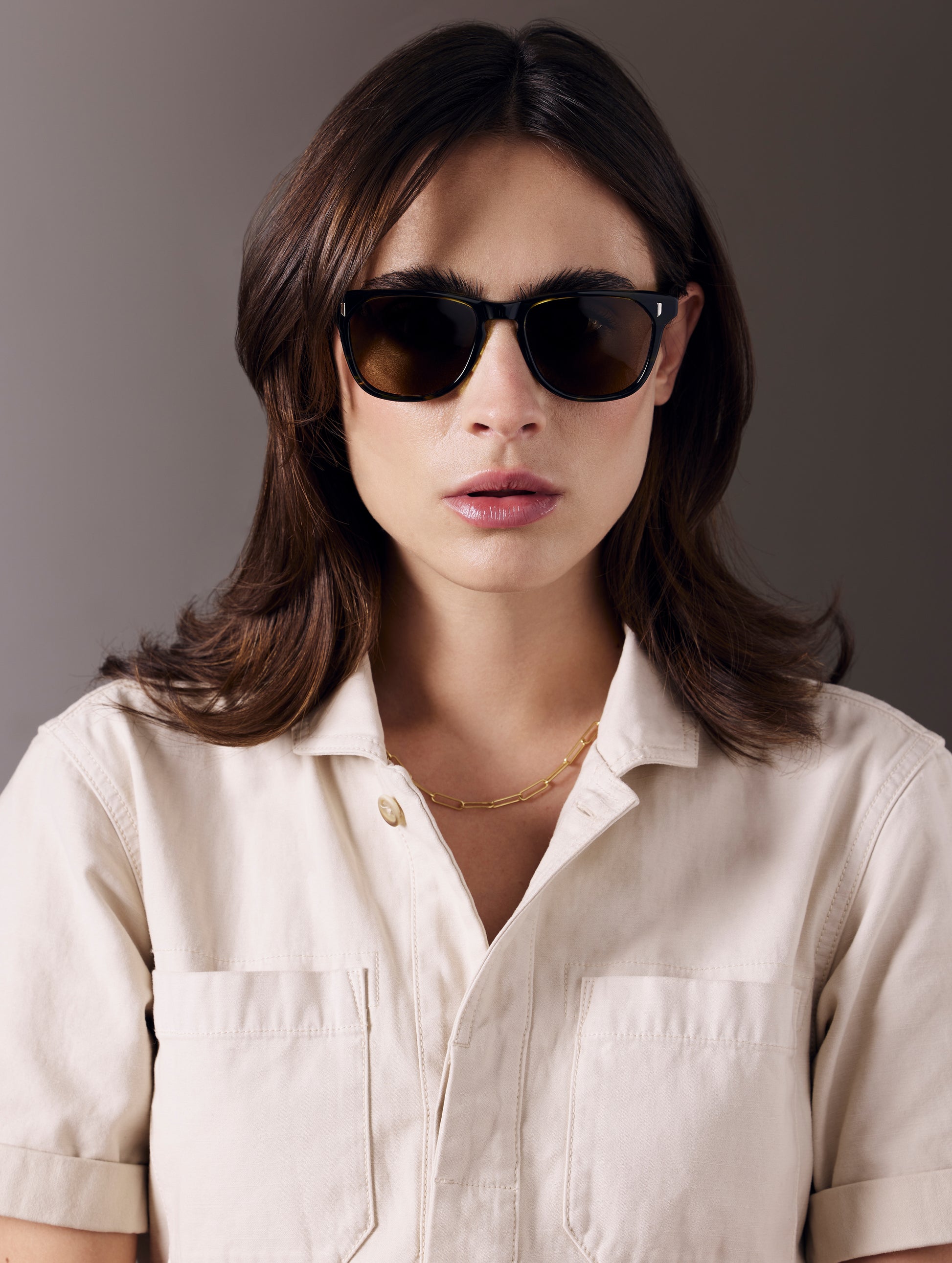 Woman wearing green tortoise sunglasses from AETHER Apparel