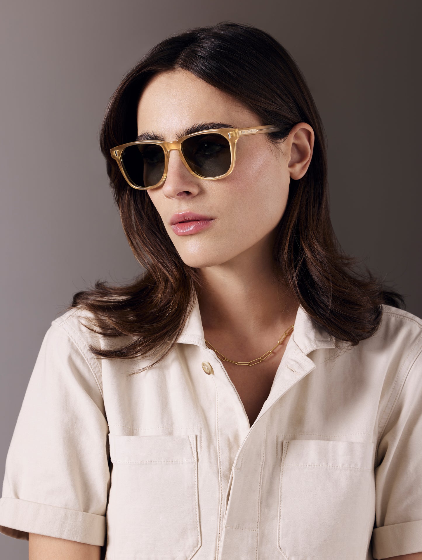 Front 3/4 view of woman wearing Yosemite Sunglass in Honey with G15 Lens from AETHER Apparel.