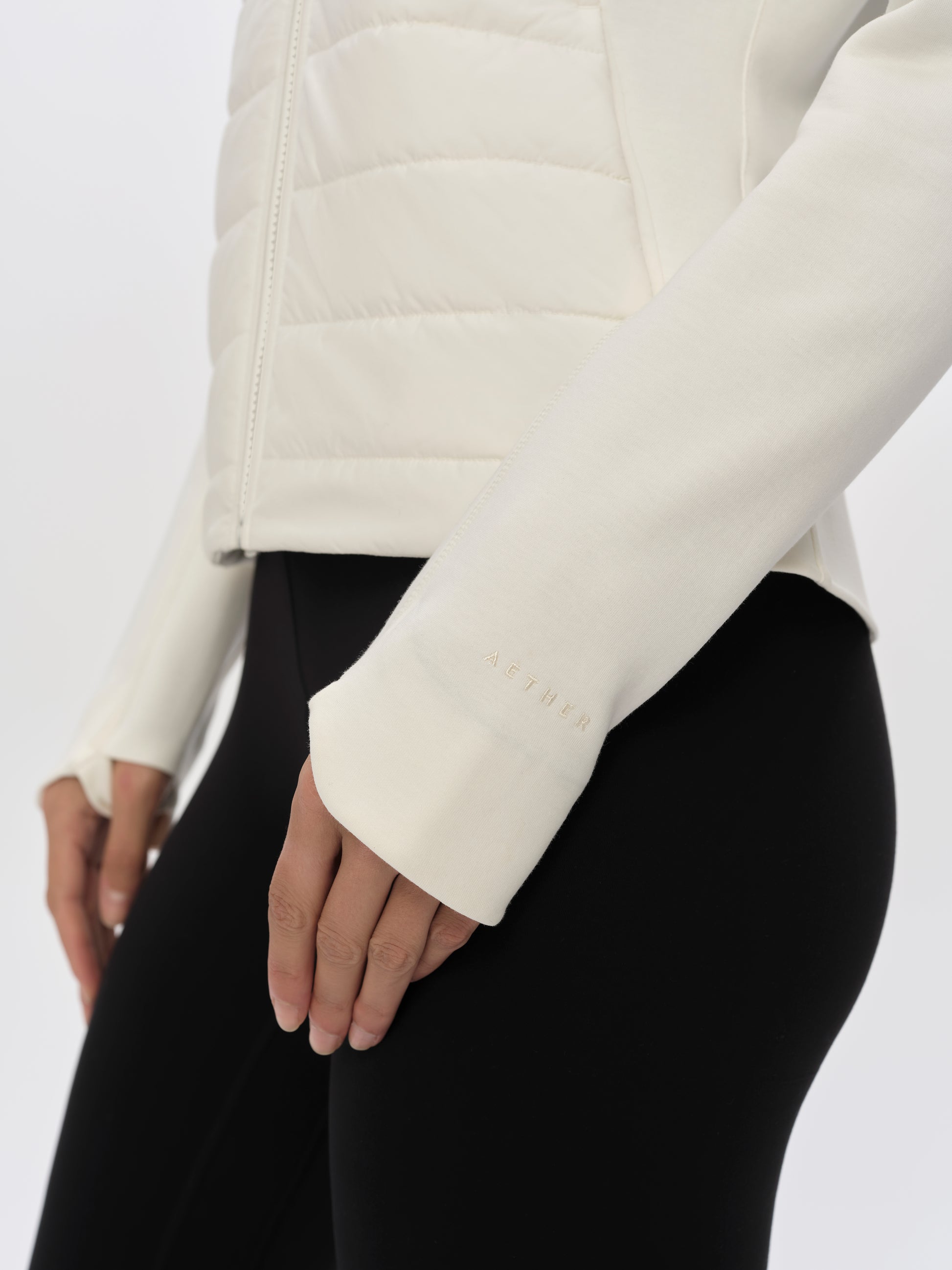 Closeup detailed view of the hem and sleeve cuffs on the W Morgan Full-Zip 2.0 in Winter White from AETHER Apparel.