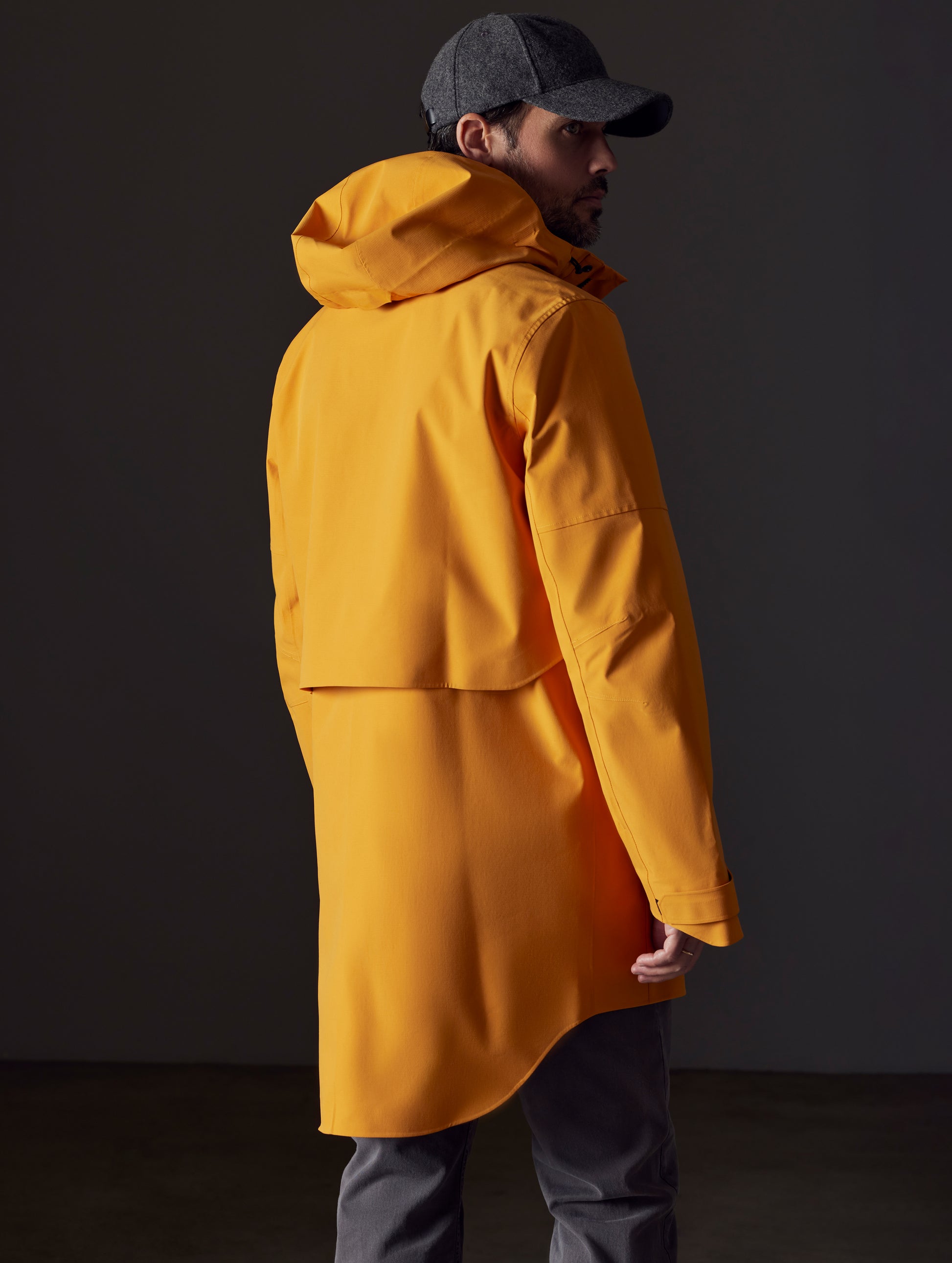 Man wearing orange rain jacket from AETHER Apparel