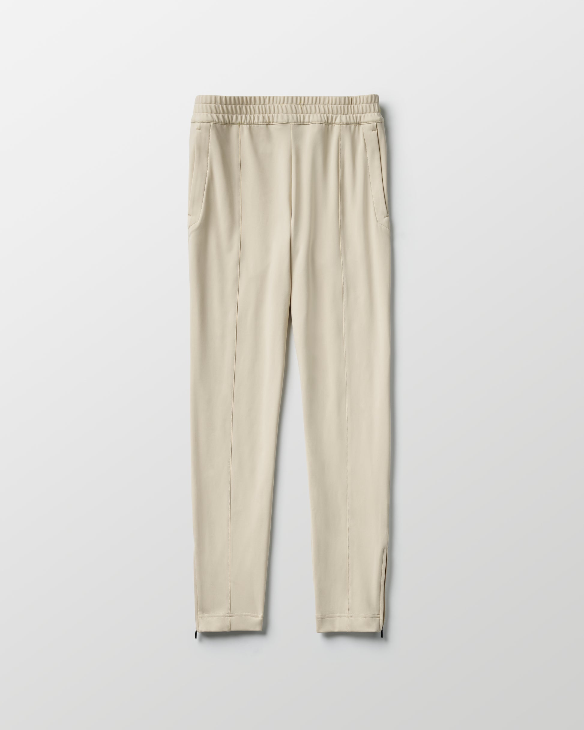 Flat lay of women's Eloise Travel Slim Pant in Bone white from AETHER Apparel.