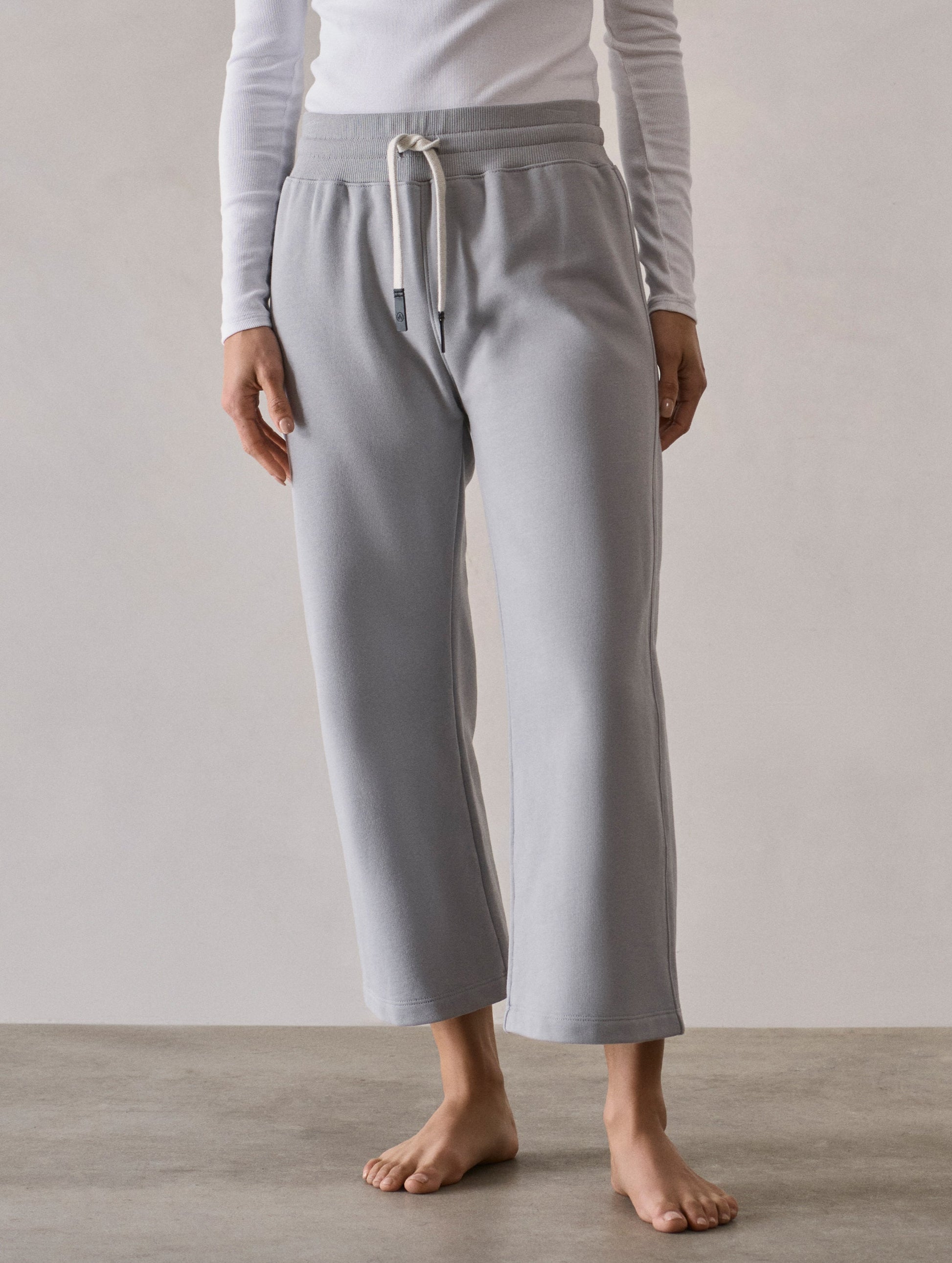 Front full-body view of woman wearing W Osa Cropped Sweatpant in Sky Grey from AETHER Apparel.