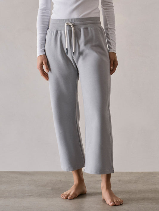 Front full-body view of woman wearing W Osa Cropped Sweatpant in Sky Grey from AETHER Apparel.