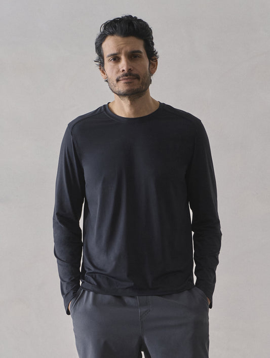 Front upper-body view of man wearing Adventure Performance Long-Sleeve Tee in Onyx Black from AETHER Apparel.