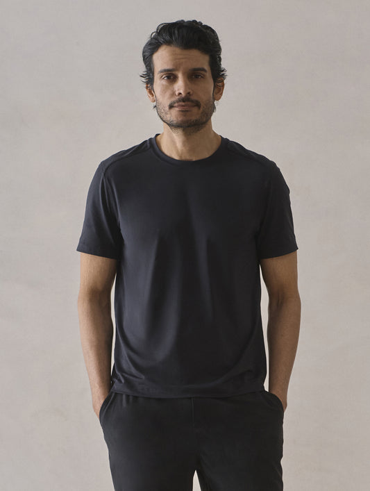 Front upper-body view of man wearing Adventure Performance Short-Sleeve Tee in Onyx Black from AETHER Apparel.