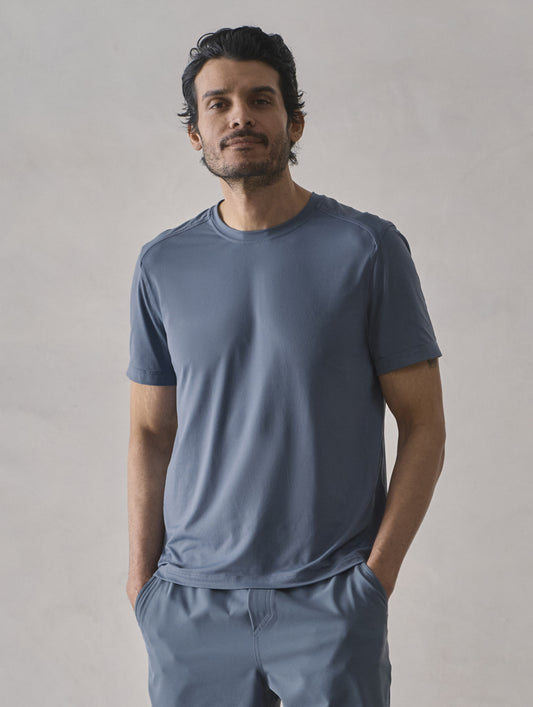 Front upper-body view of man wearing Adventure Performance Short-Sleeve Tee in Portal Blue from AETHER Apparel.