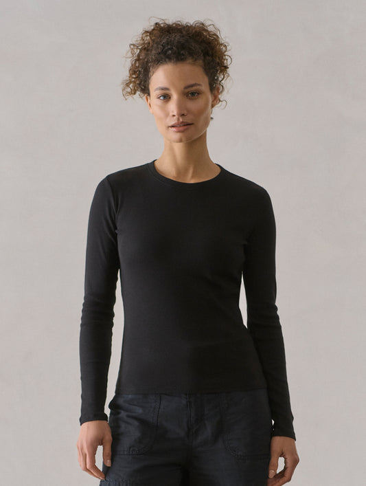 Front view of woman wearing Amara Long-Sleeve Crew in Onyx Black from AETHER Apparel.