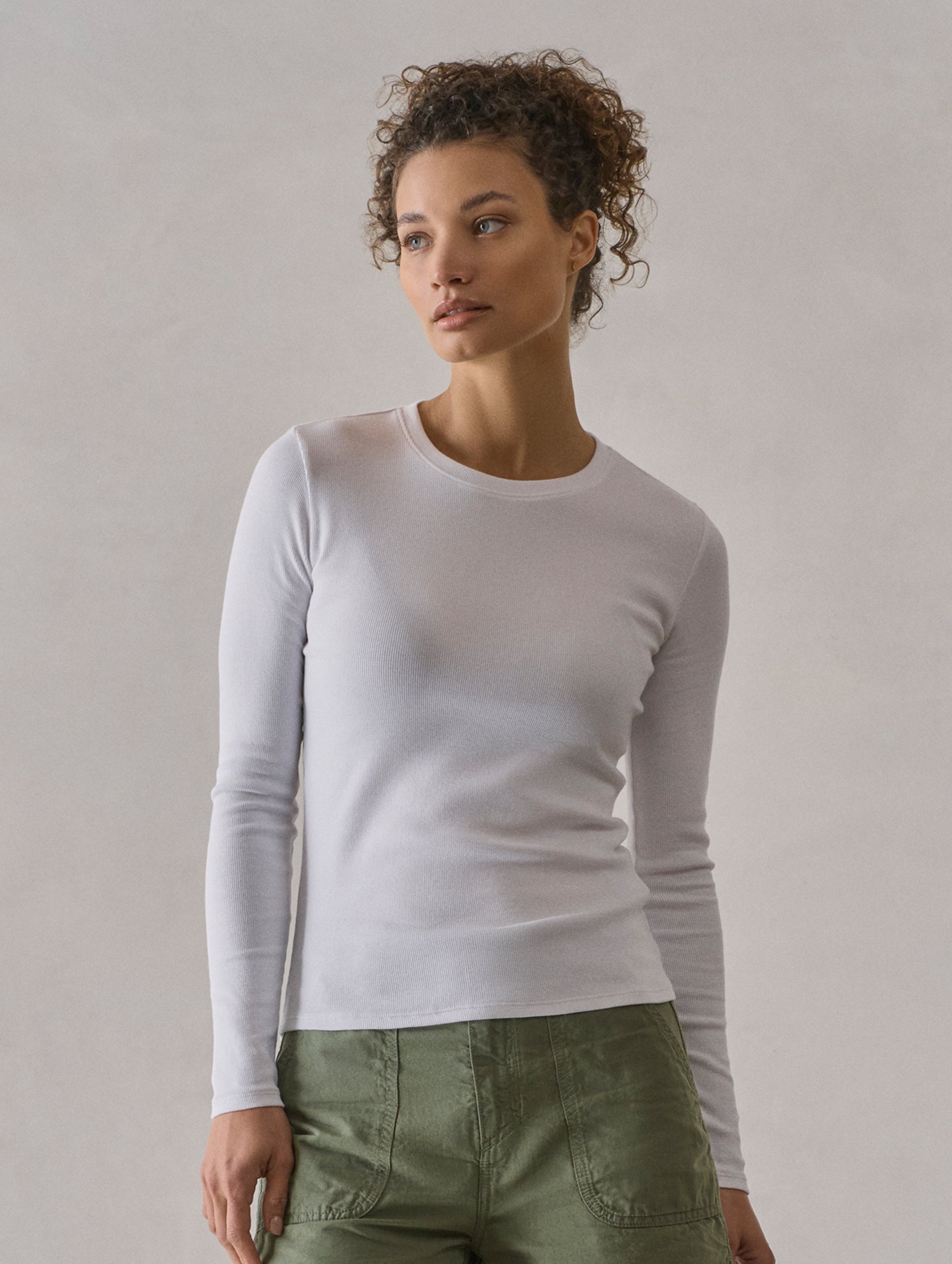 Front body view of woman wearing Amara Long-Sleeve Crew in White from AETHER Apparel.