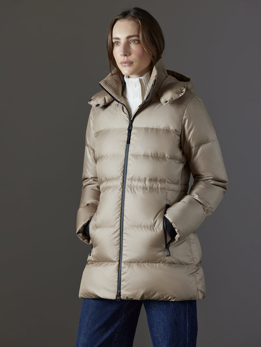 Front angled view of woman with hands in pockets wearing Aura Puffer Long in Chinchilla Brown from AETHER Apparel.