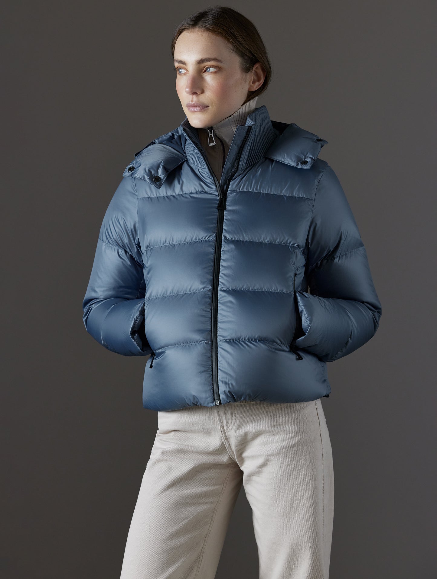 woman wearing blue puffer jacket from AETHER Apparel