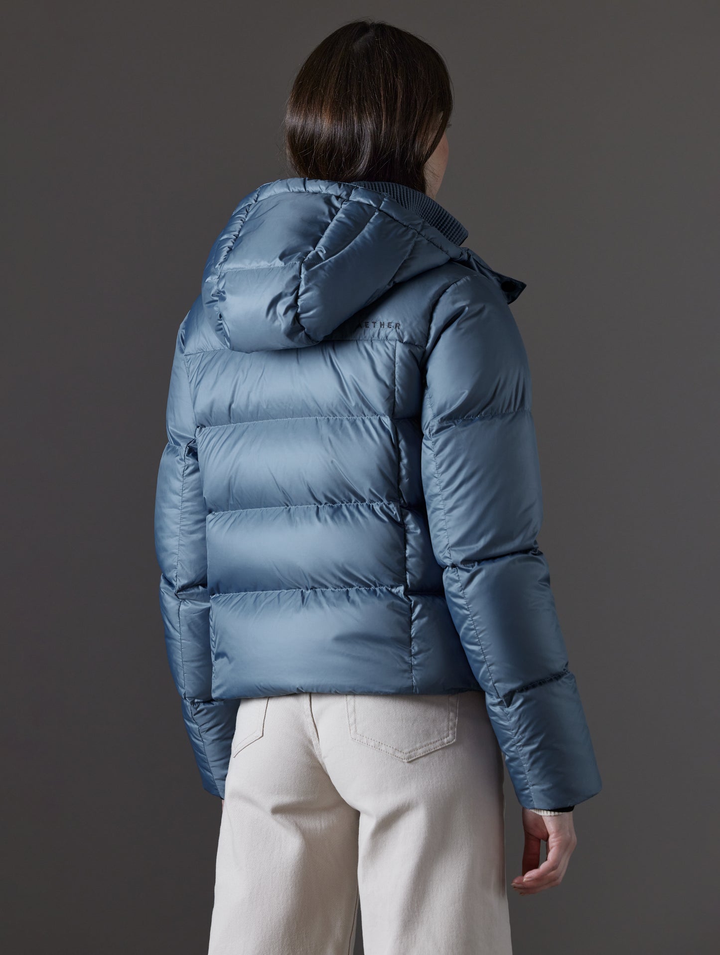 woman wearing blue puffer jacket from AETHER Apparel