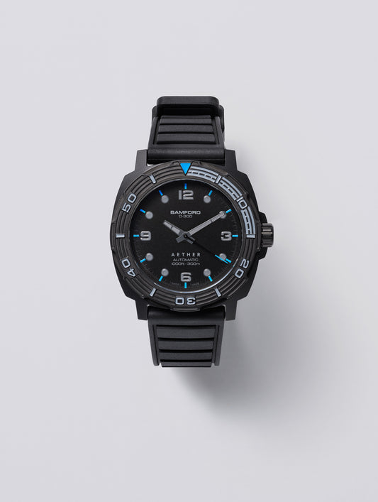 Front view of the AETHER + Bamford D-300 showing the black dial, Summit Blue markers and ceramic dive bezel.