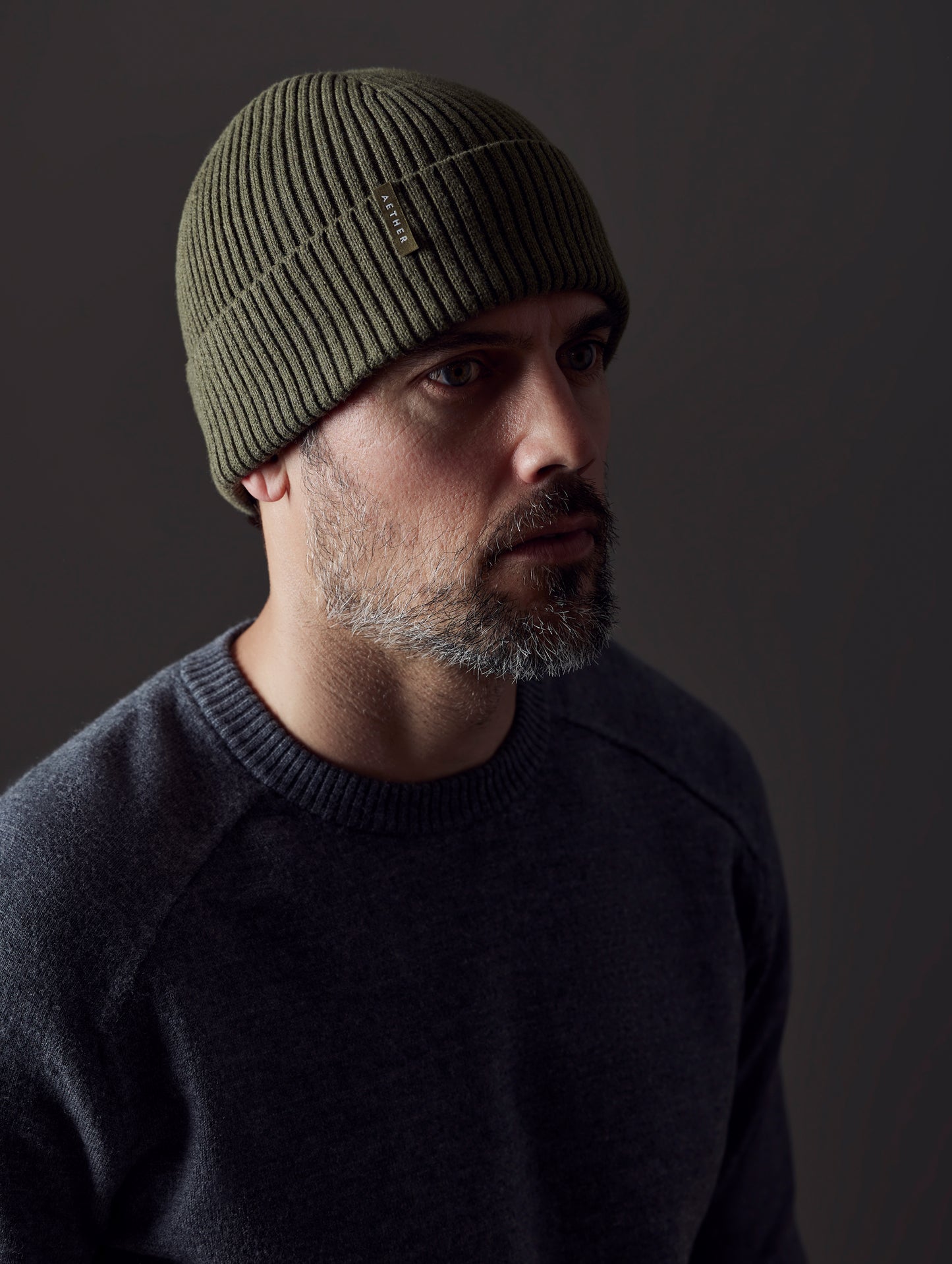 man wearing green cotton beanie from AETHER Apparel