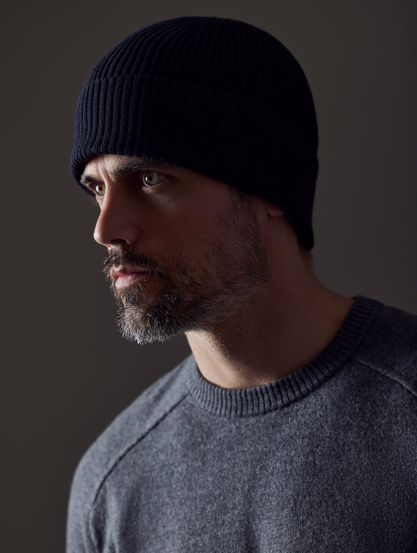 man wearing black cotton beanie from AETHER Apparel