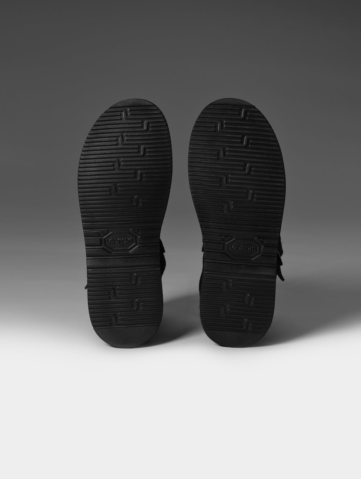 Studio shot of the Vibram outsoles on the Sam Buckle Shoe in Cement from AETHER Apparel.