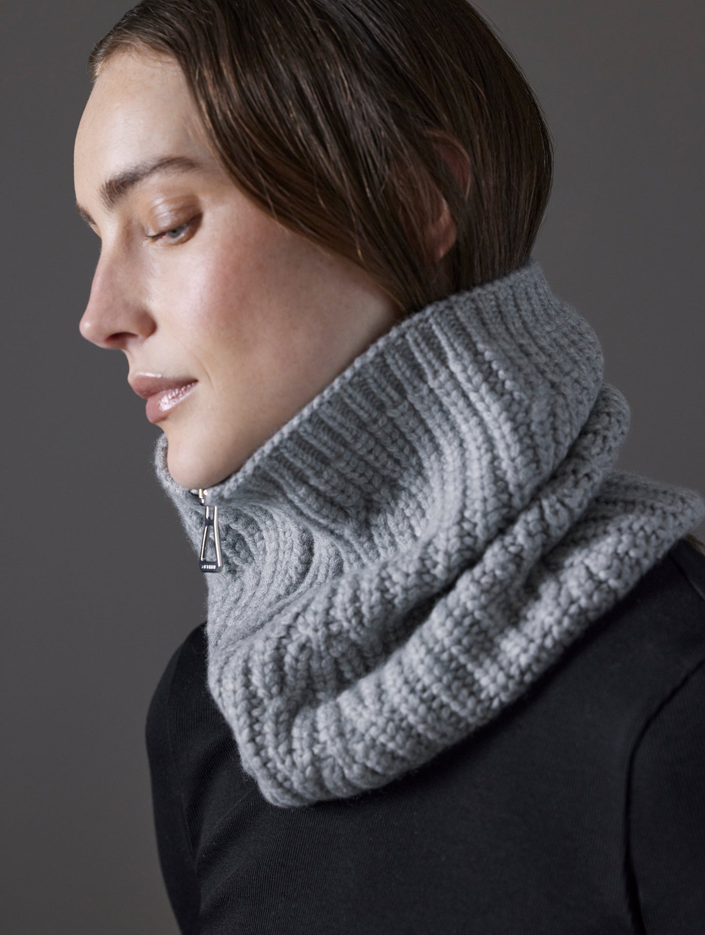 Closeup side profile view of woman wearing Sweater Neck Gaiter 2.0 in Light Heather Grey from AETHER Apparel. 