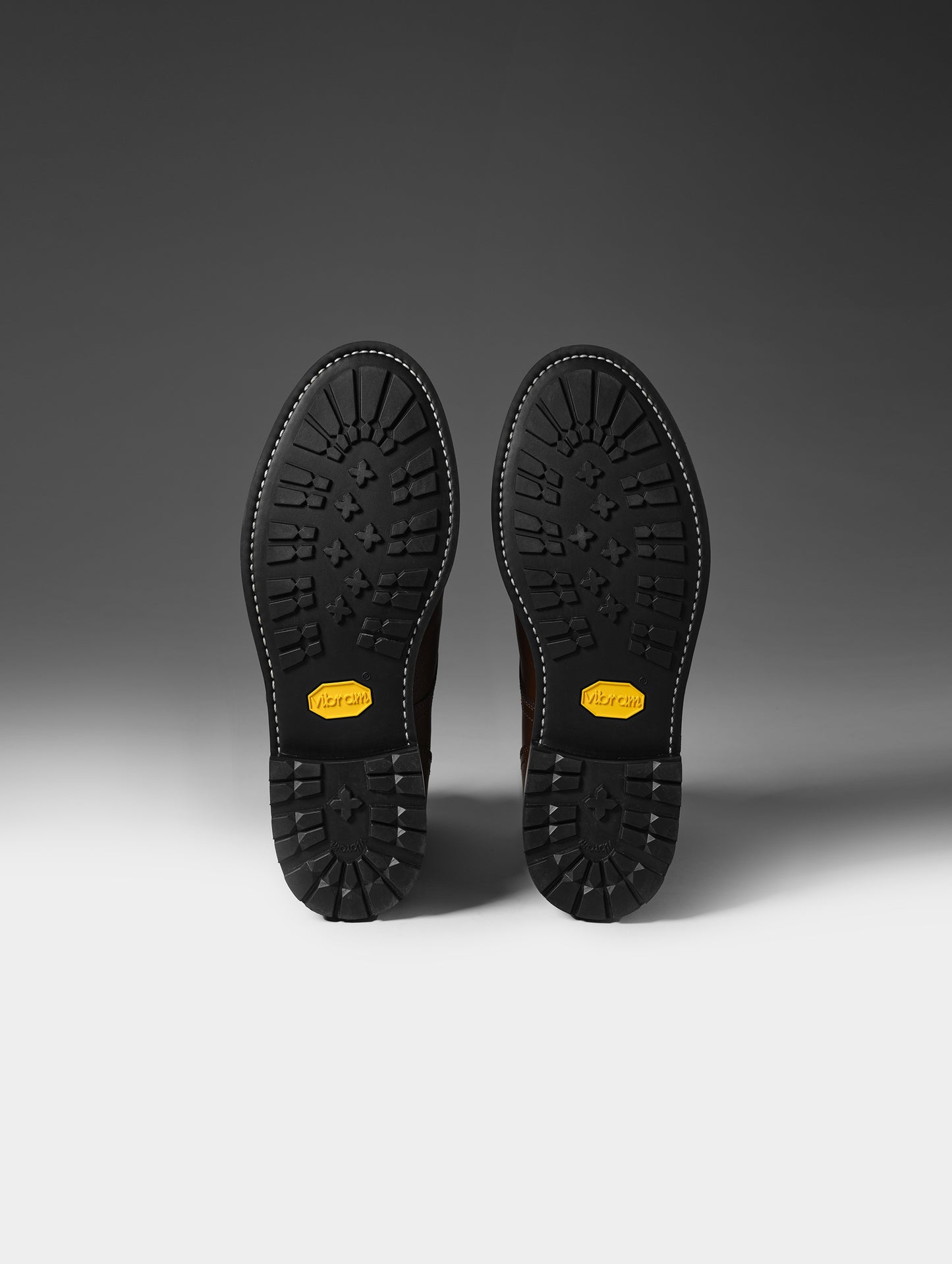 Bottom view of the Vibram outsoles on the Tioga Moto Boot in Espresso Brown from AETHER Apparel.