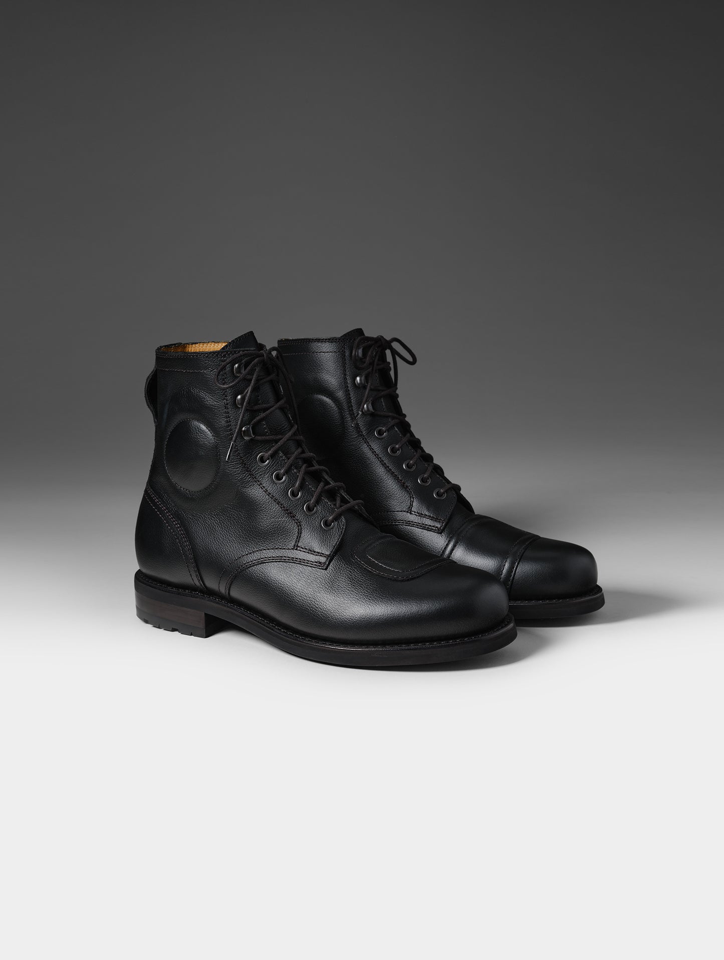 Front 3/4 studio shot of the Tioga Moto Boot in Onyx Black with black laces from AETHER Apparel.