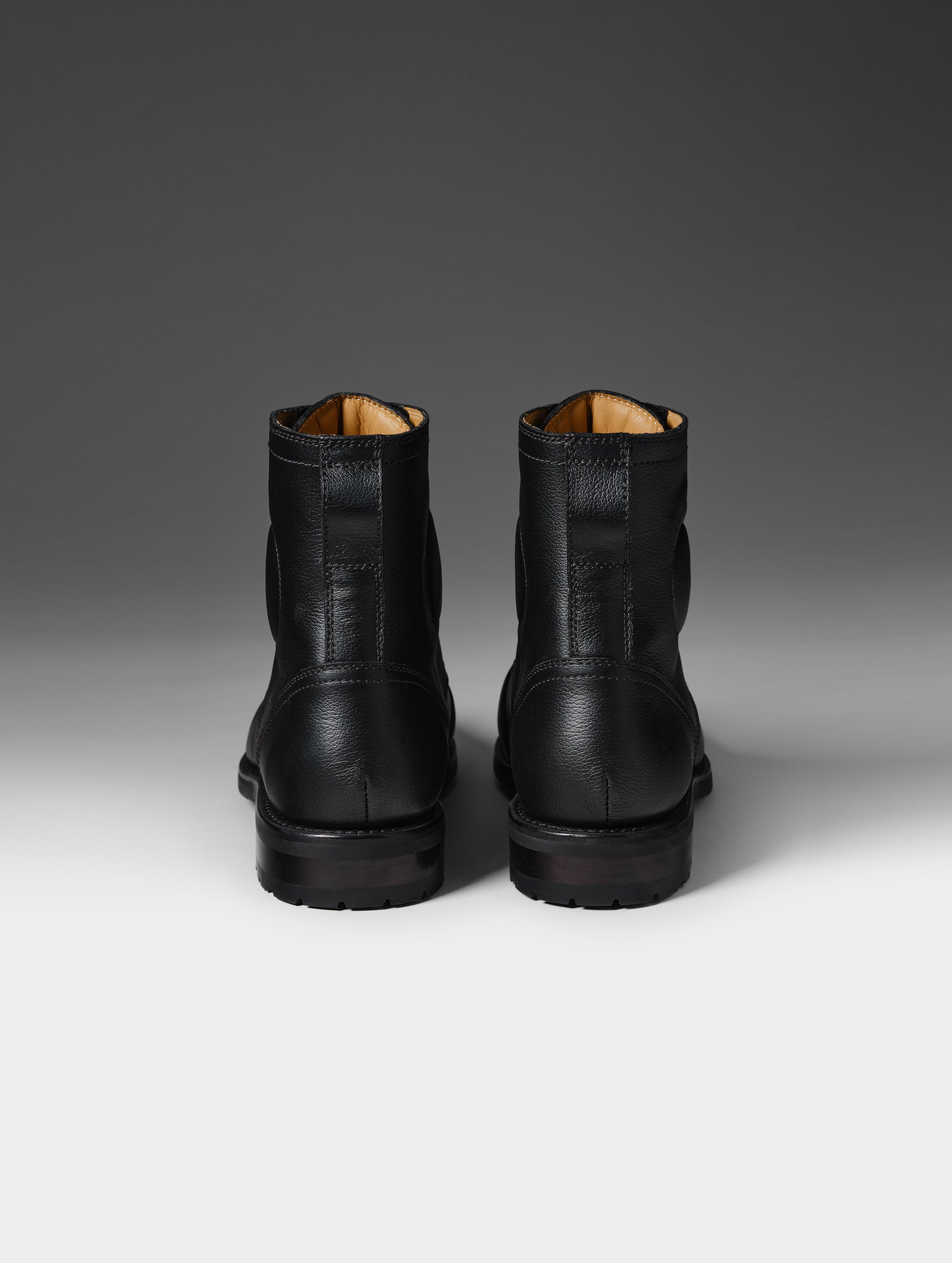 Rear studio shot of the Tioga Moto Boot in Onyx Black from AETHER Apparel.