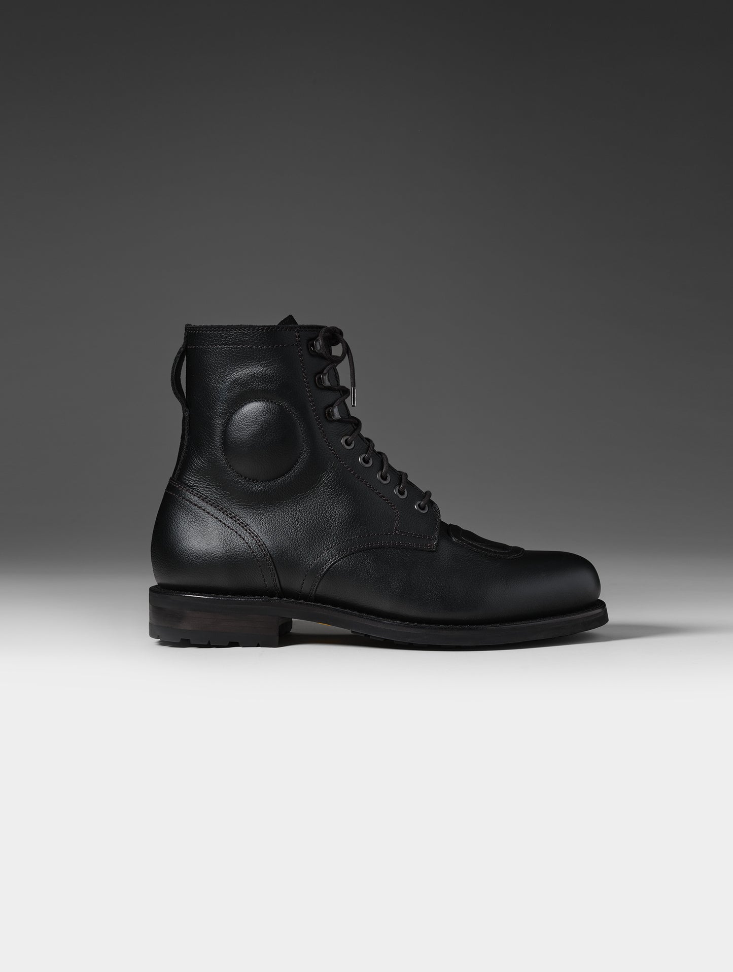 Side, profile view of the Tioga Moto Boot in Onyx Black with black laces from AETHER Apparel.
