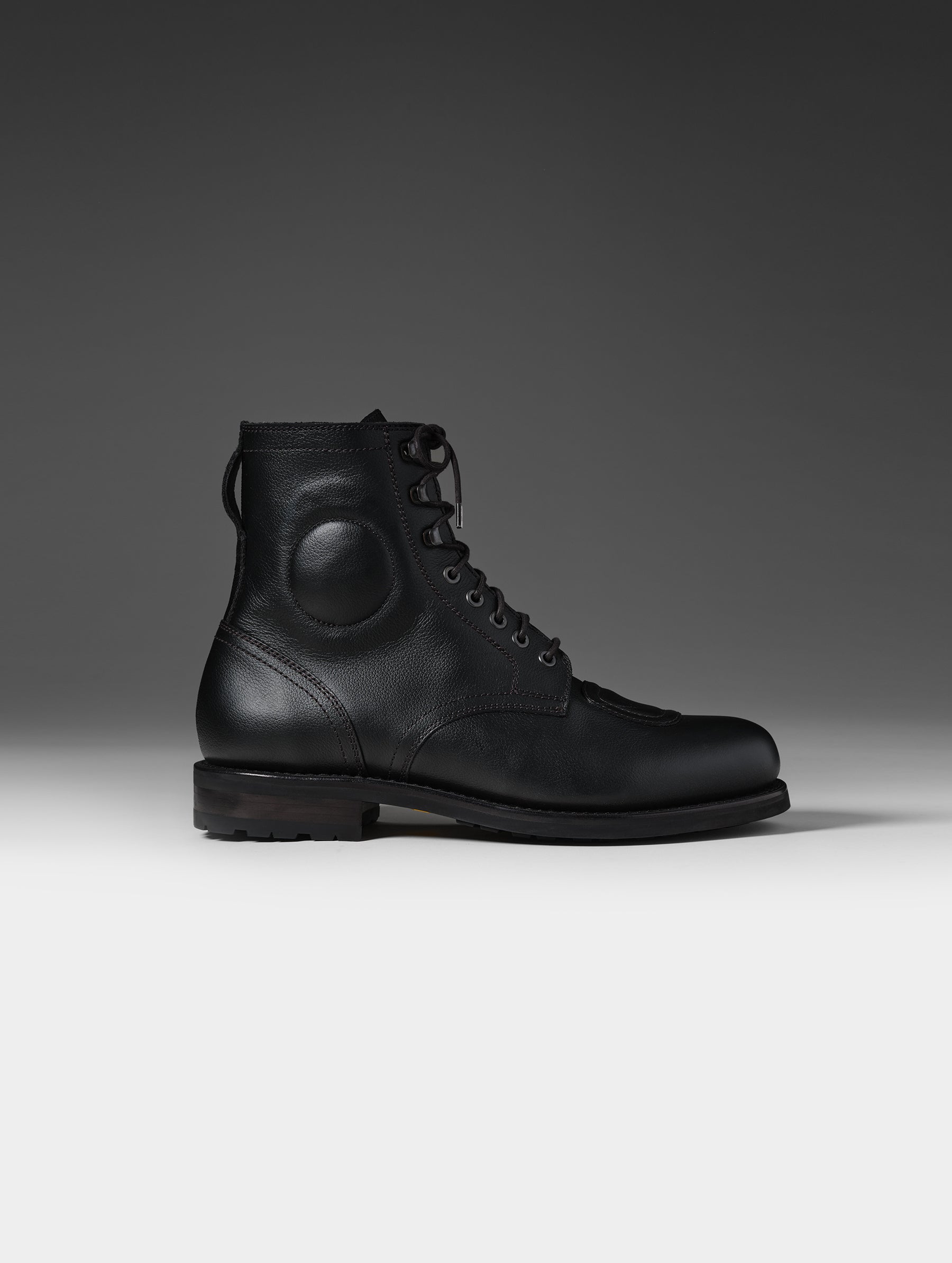 Side, profile view of the Tioga Moto Boot in Onyx Black with black laces from AETHER Apparel.