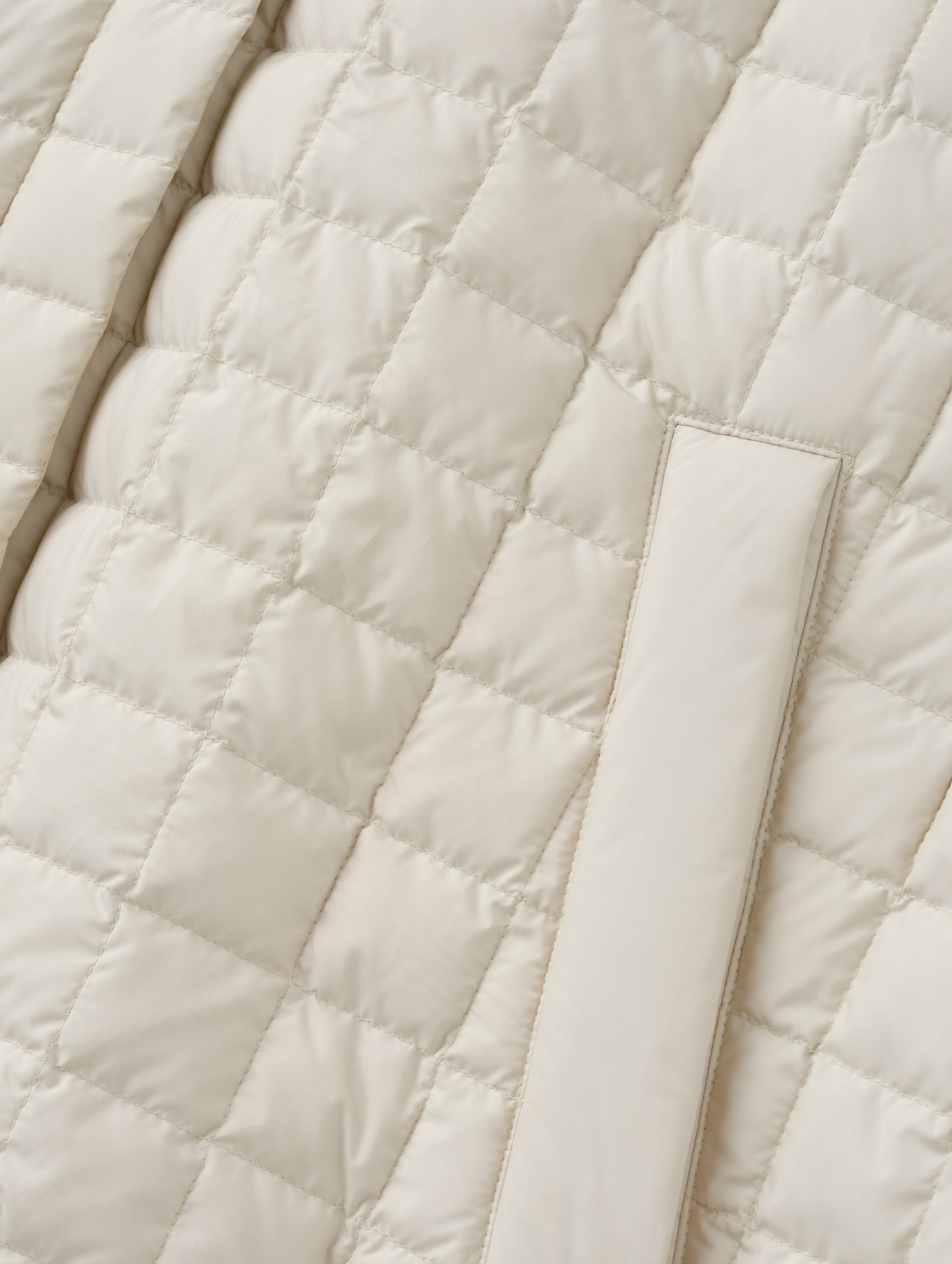 Closeup detailed view of the hand pockets on the Bardo Hooded Poncho in Bone from AETHER Apparel.