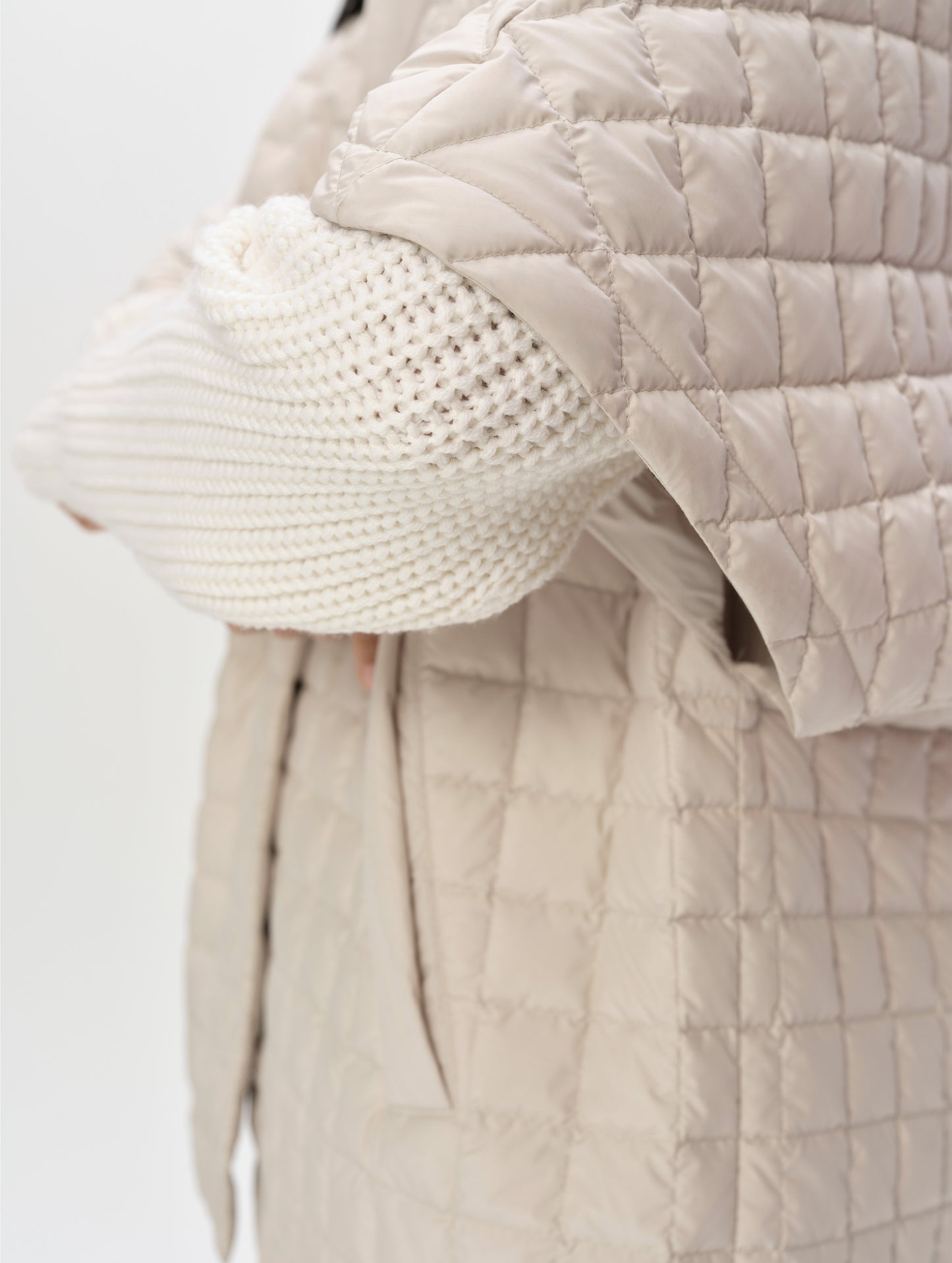 Closeup detailed view of the Dolman sleeves on the Bardo Hooded Poncho in Bone from AETHER Apparel.
