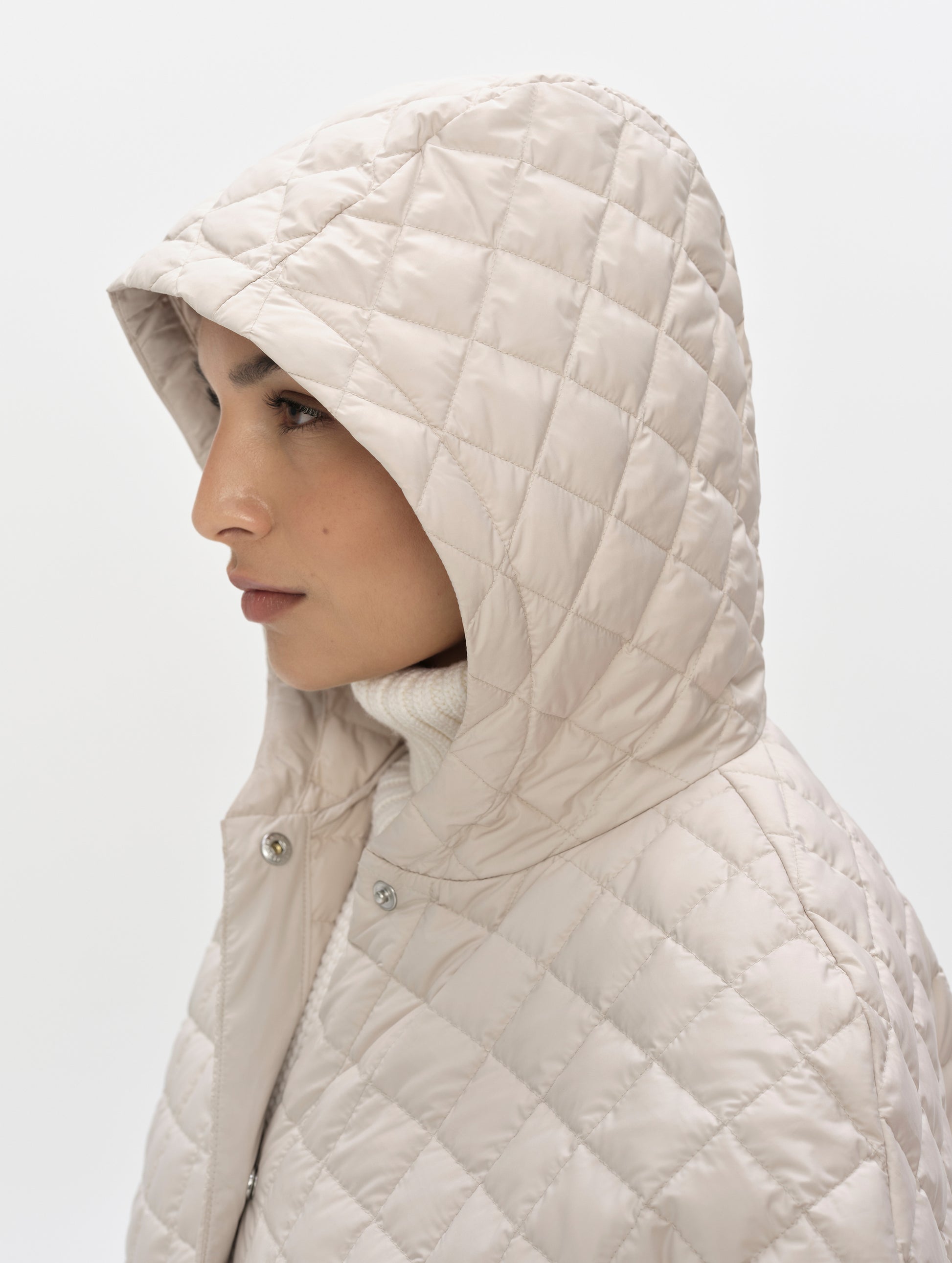 Closeup detailed view of the quilted, three-piece hood on the Bardo Hooded Poncho in Bone from AETHER Apparel.
