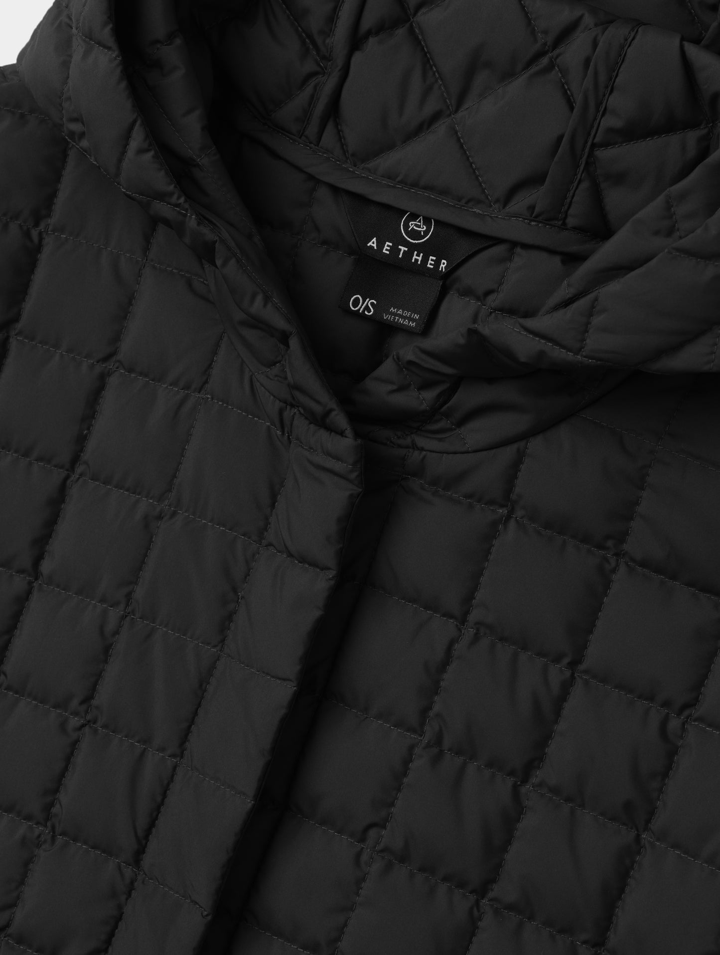 Closeup detailed view of the collar and hidden center-front closure on the Bardo Hooded Poncho in Onyx Black from AETHER Apparel.