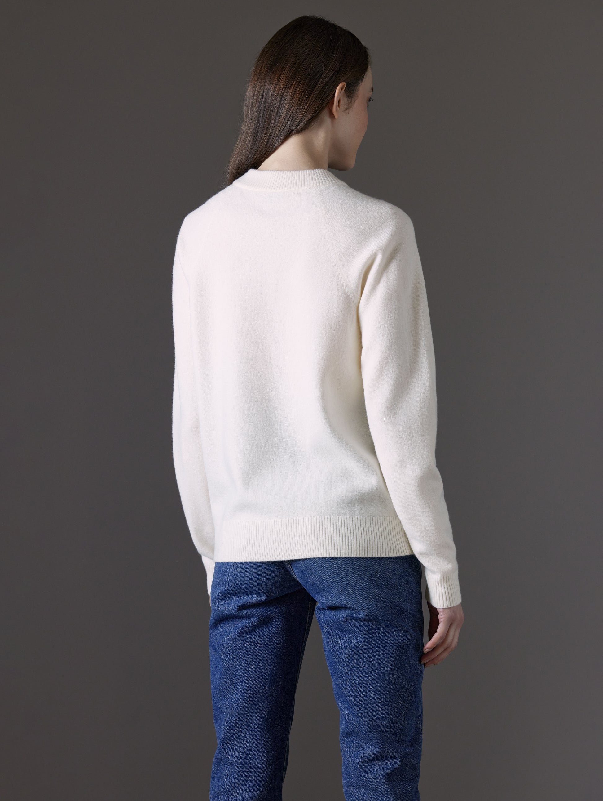 Woman wearing white sweater from AETHER Apparel