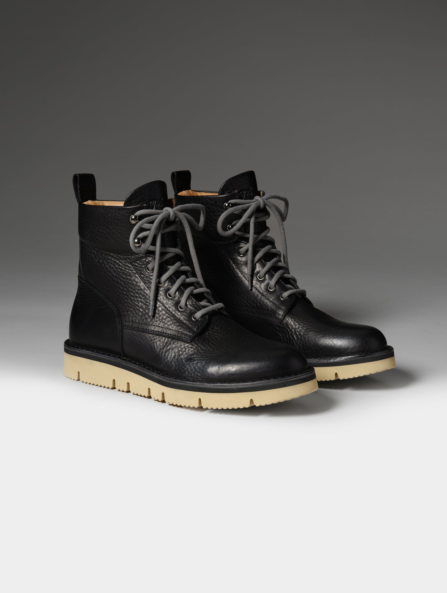 Front 3/4 studio shot of the Canyon Boot in Onyx Black with grey laces from AETHER Apparel.