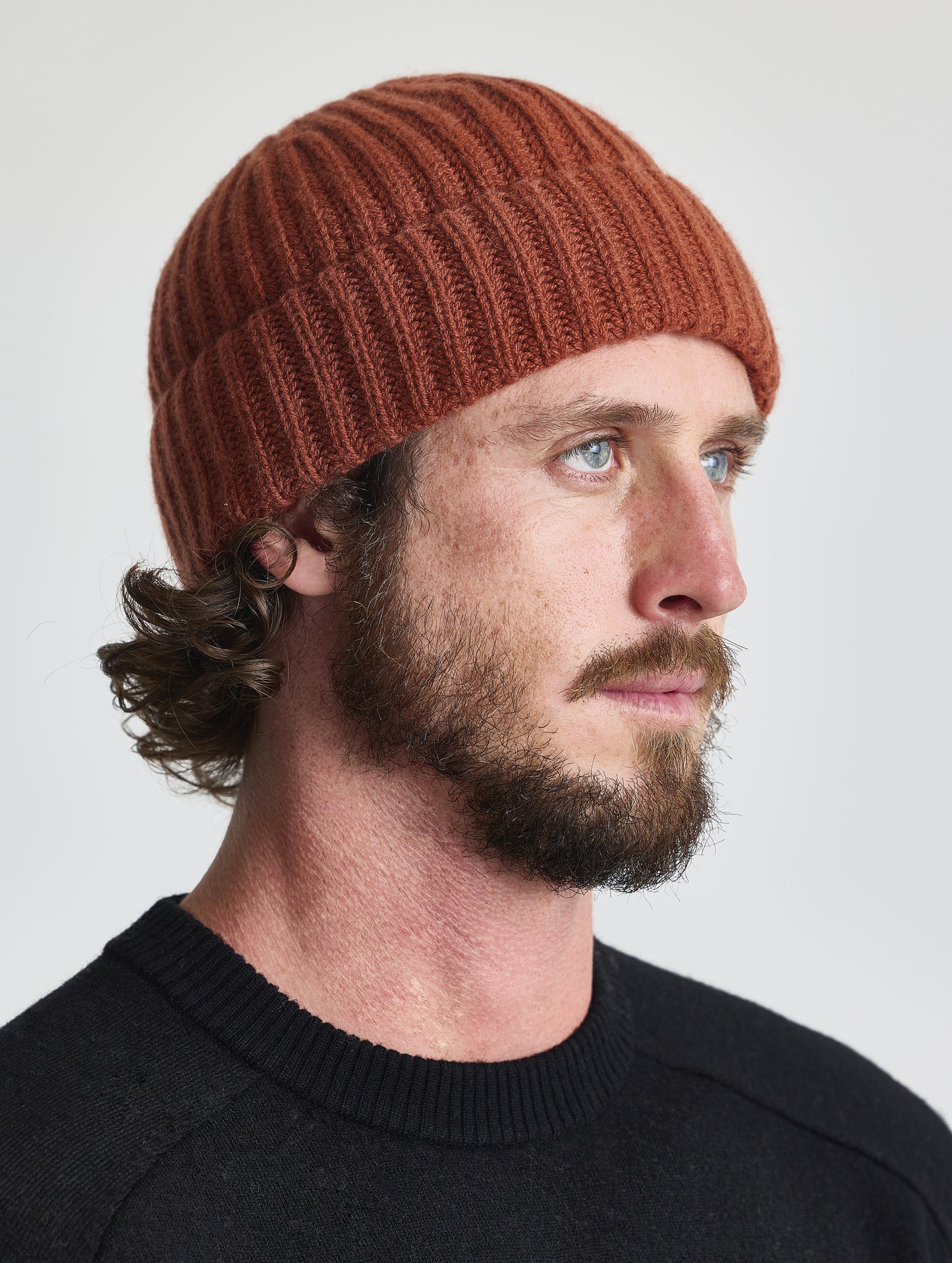 Front angled view of man wearing the Cashmere Hat in Redwood Rust from AETHER Apparel.