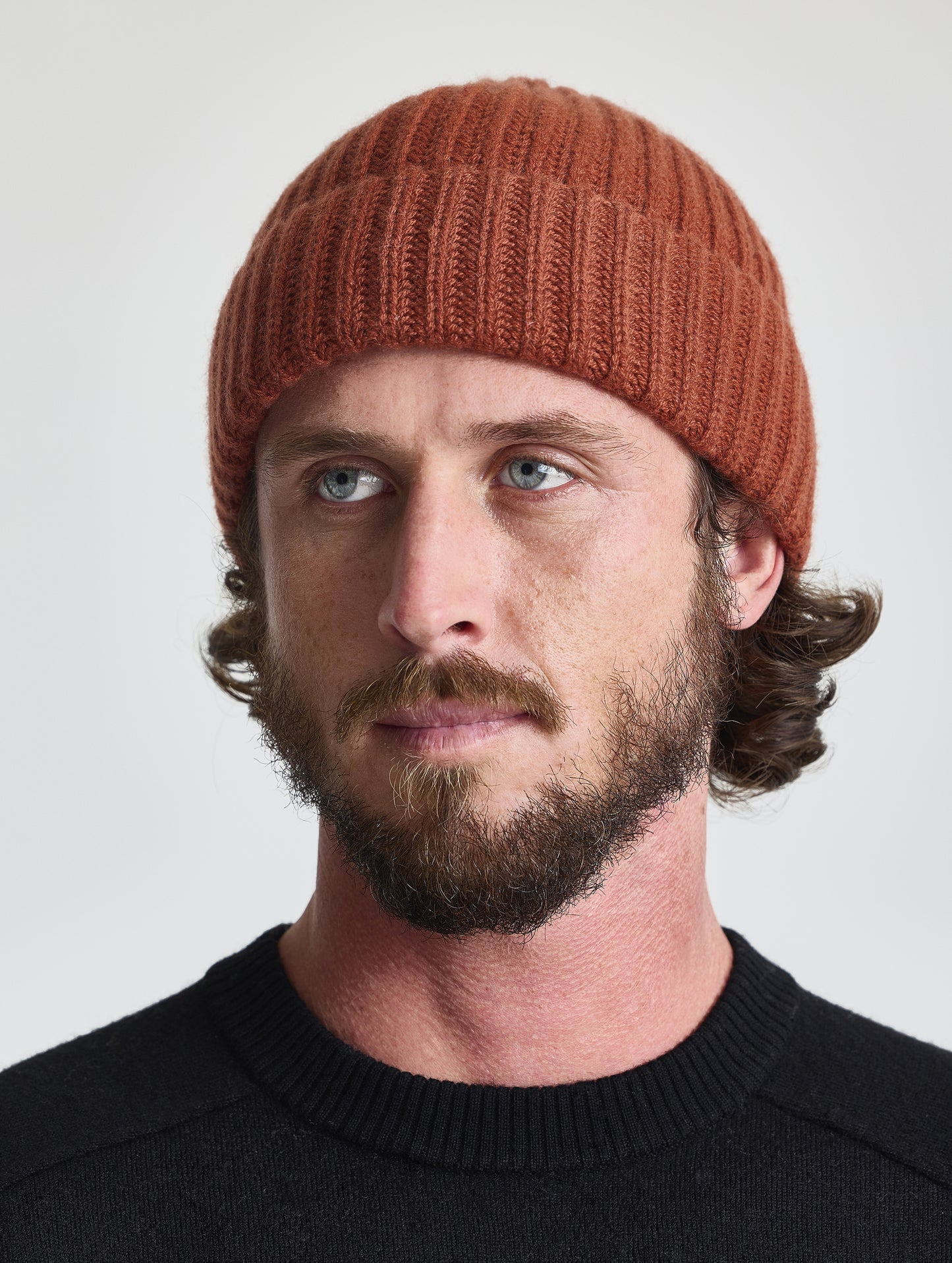 Front view of man wearing the Cashmere Hat in Redwood Rust from AETHER Apparel. 
