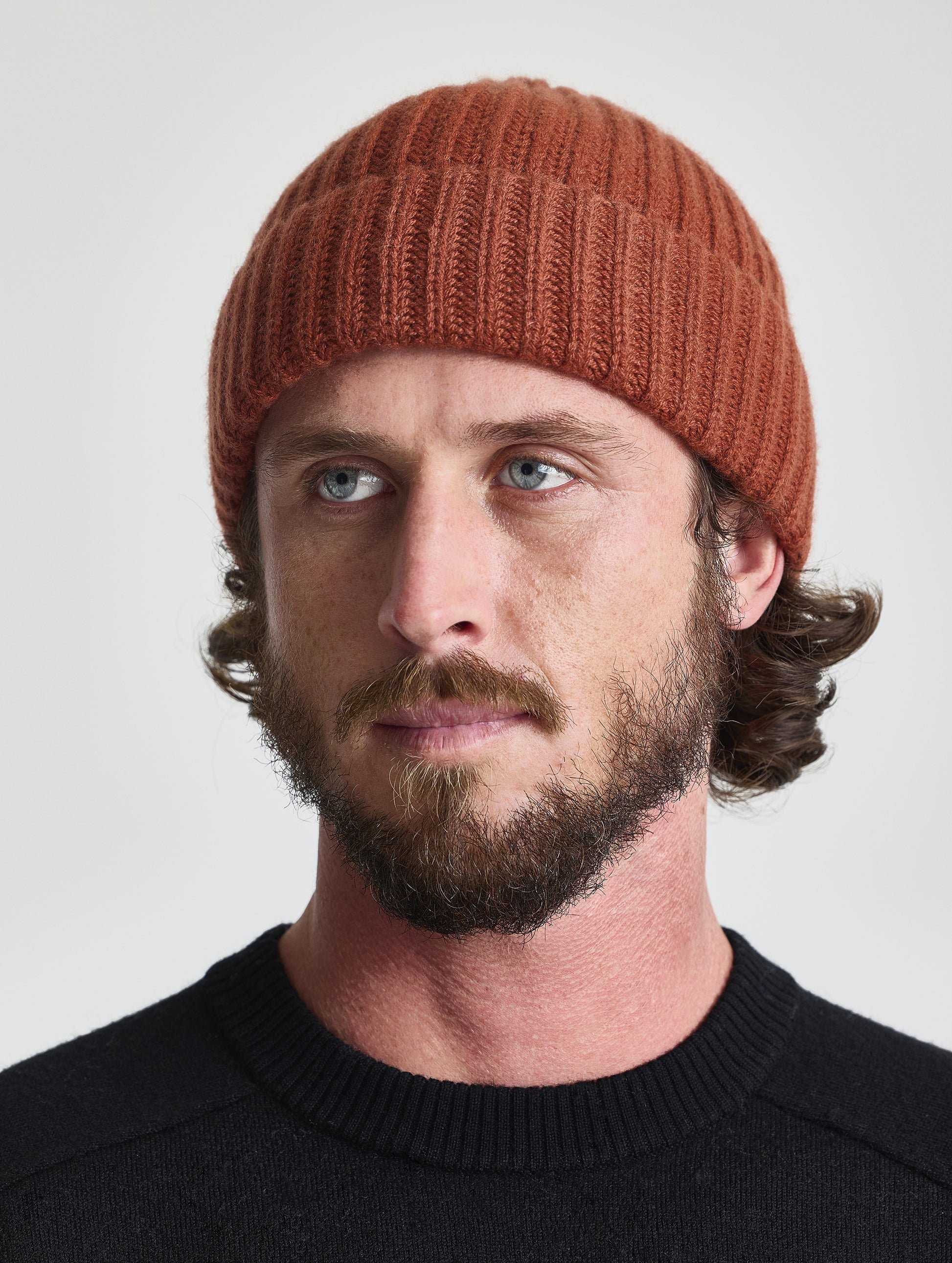 Front view of man wearing the Cashmere Hat in Redwood Rust from AETHER Apparel. 
